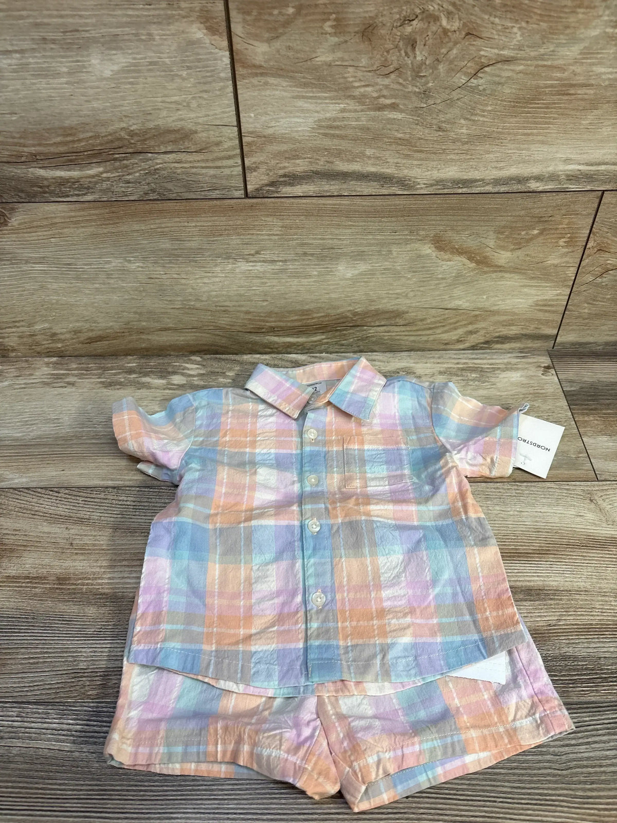 Front view of coral plaid 2-piece baby shirt and shorts set (12m), button-front top and elastic-waist shorts white background