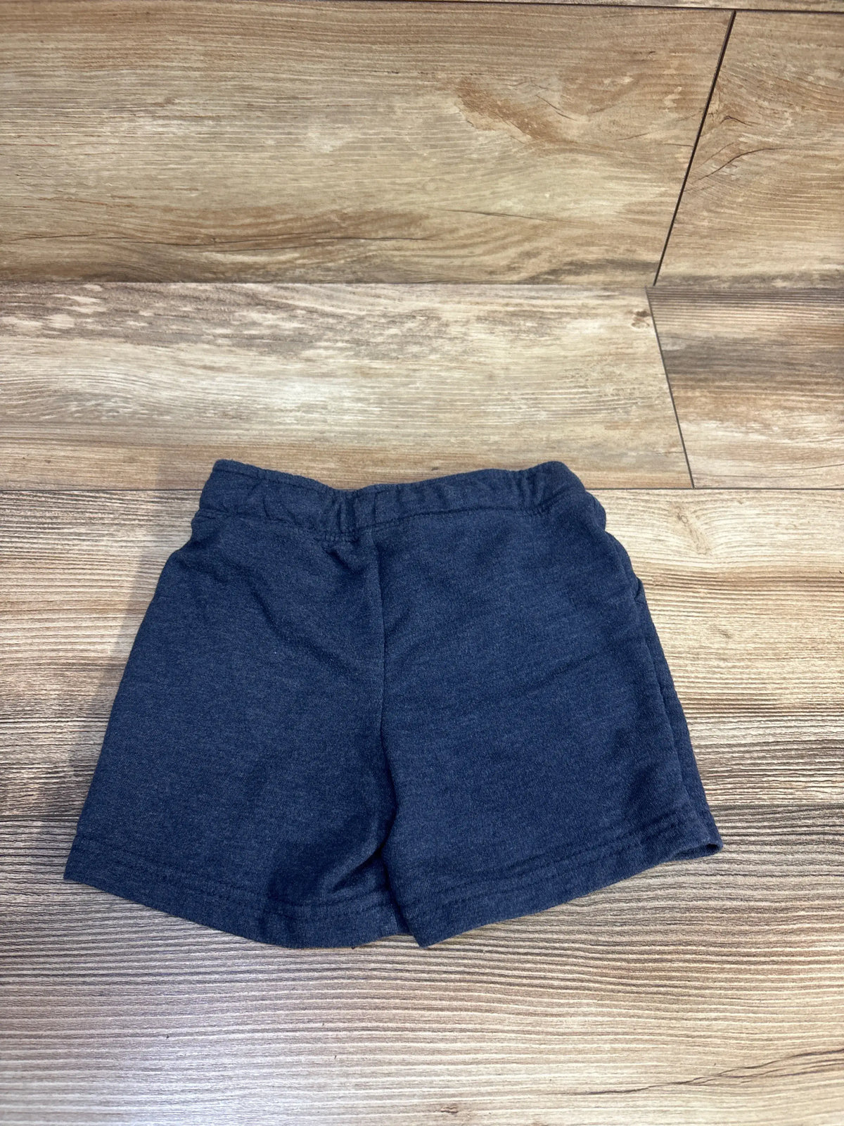 Cat & Jack navy blue drawstring shorts for toddlers size 2T on a wooden background