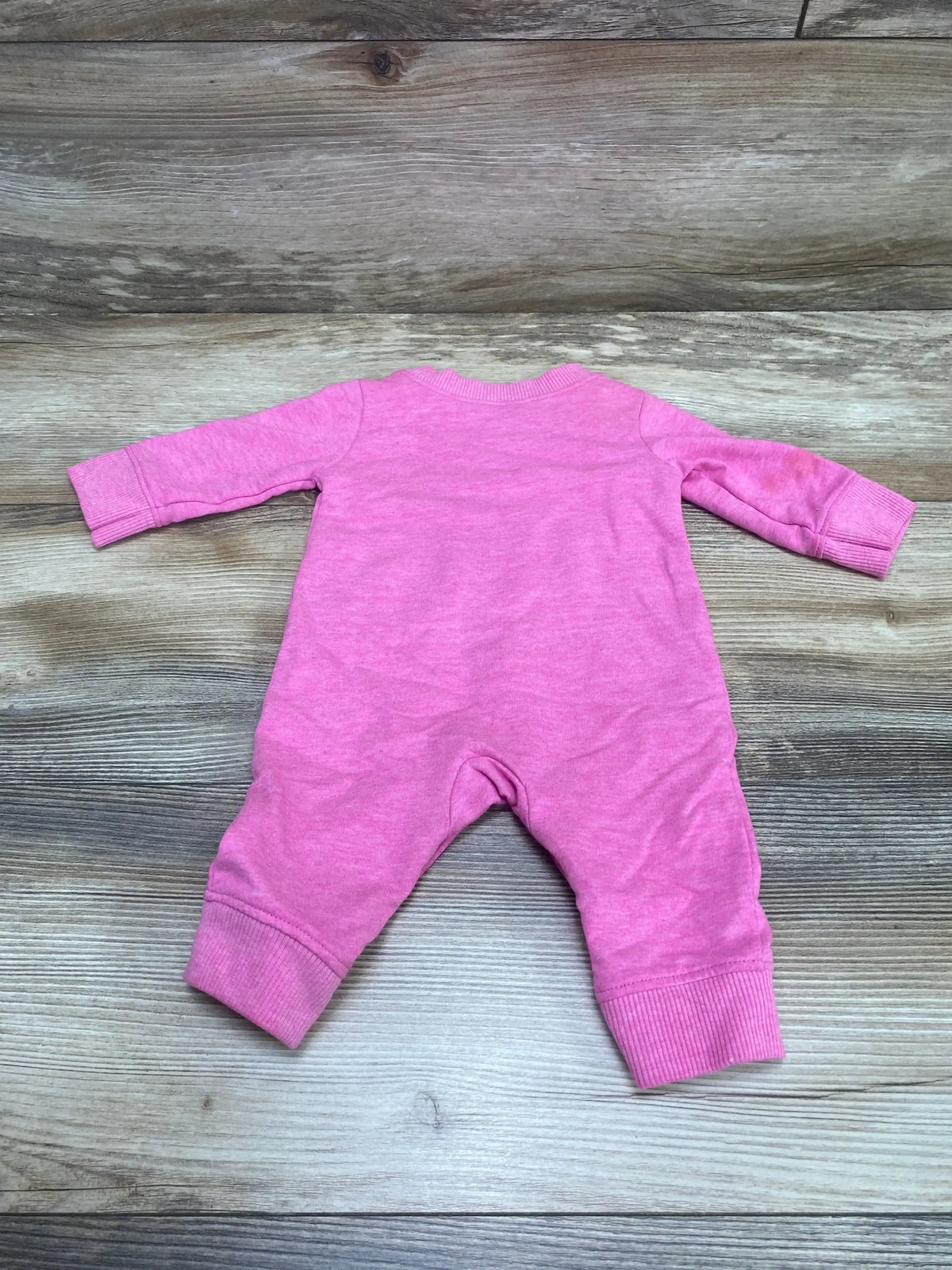 Back view of Carter’s Instafamous pink coverall size 3 months showing long sleeves and ribbed ankle cuffs on wood plank background