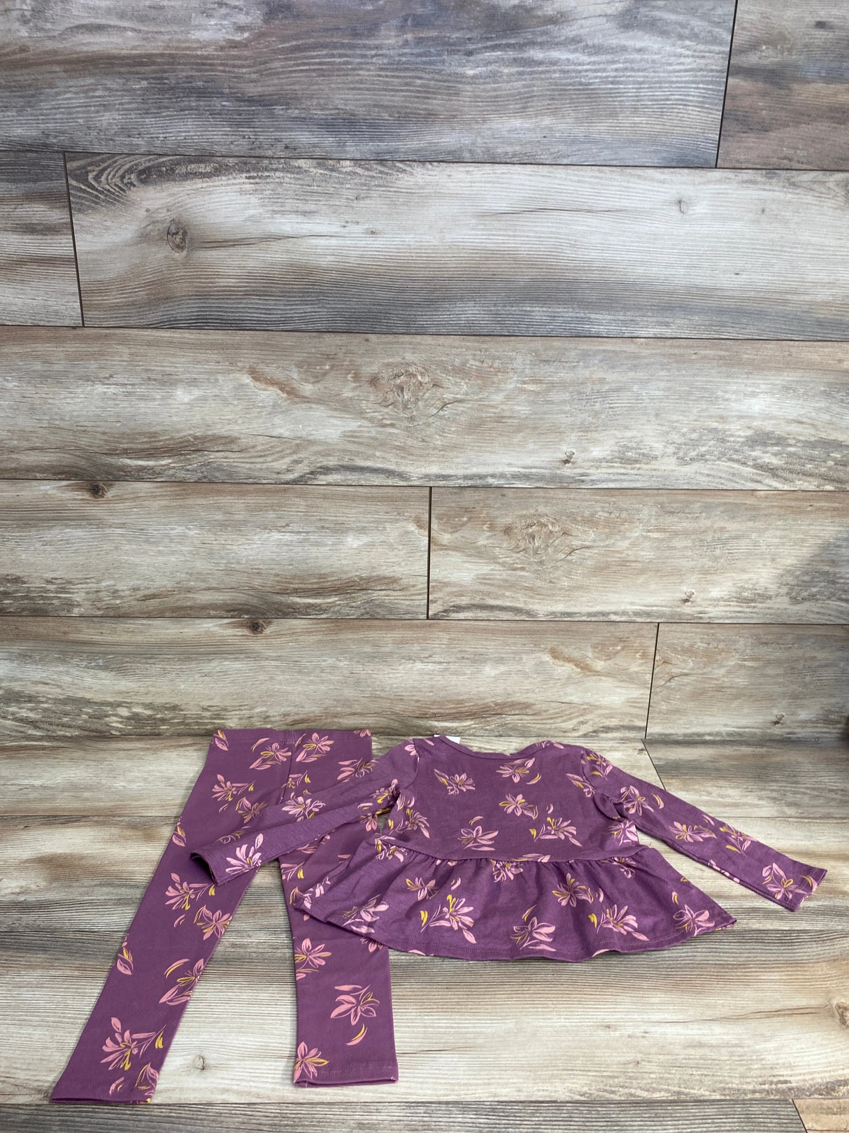 Purple long-sleeve floral baby outfit with matching leggings on wooden floor background