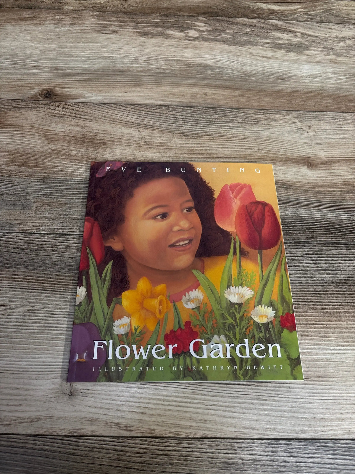 Children's book Flower Garden by Eve Bunting with illustration of a girl and colorful spring flowers