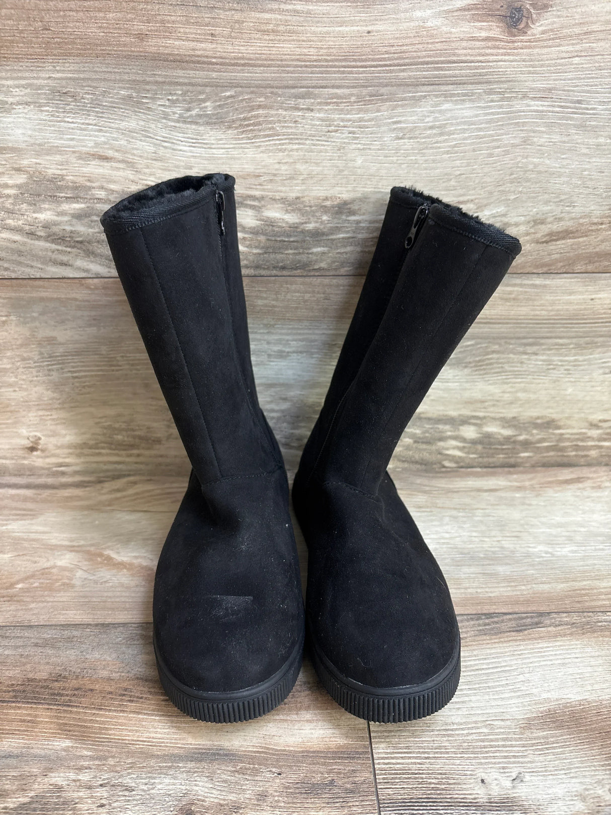 Front view of Cat & Jack Natalia tall shearling-style boots, black sz 5Y, faux fur lining and rubber soles on wood floor