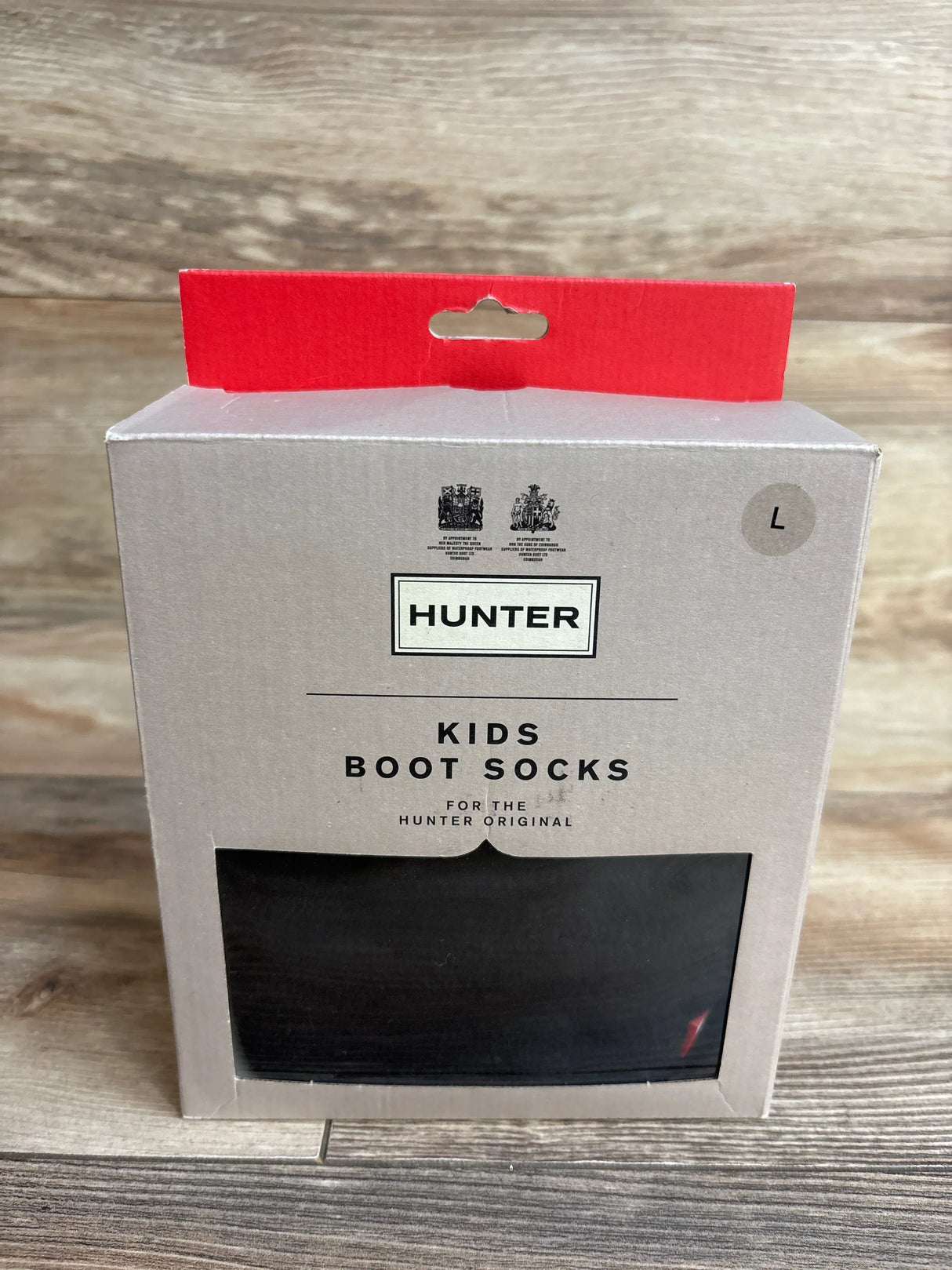 Hunter kids boot socks in original packaging, size large, on wood background