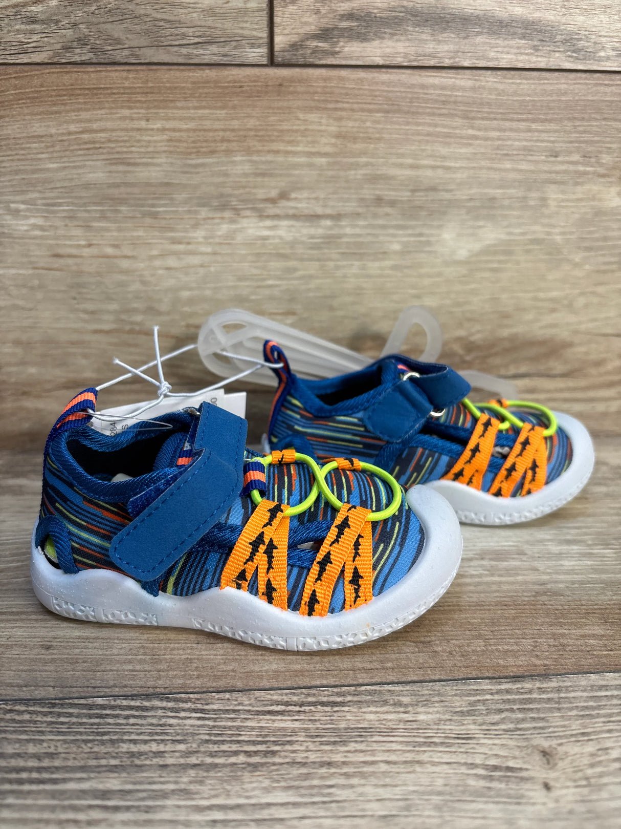 Colorful toddler athletic sandals with Velcro straps, blue, orange, and neon green accents