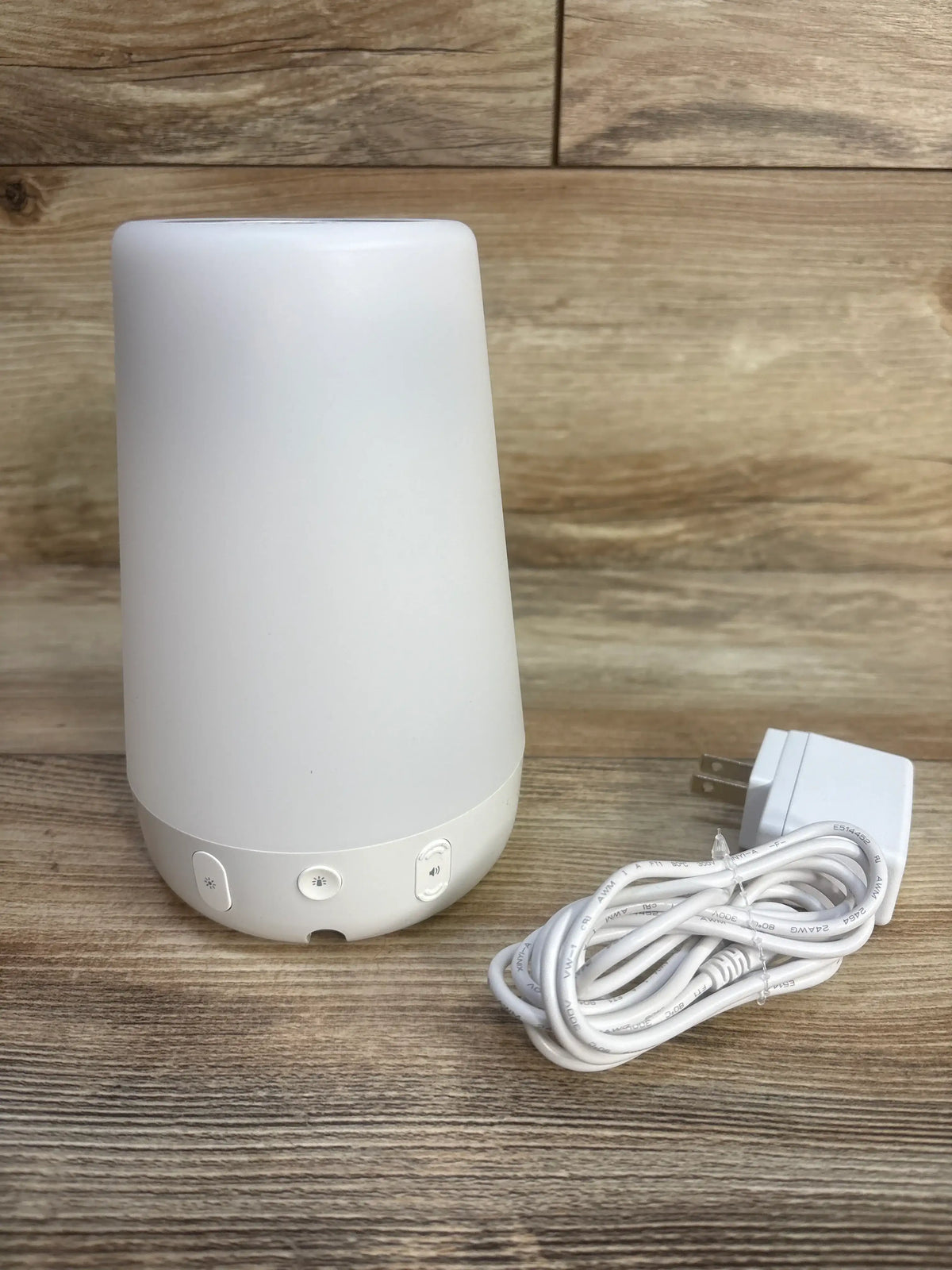 Lovevery Organic Cotton Sensory Pouch listing image appears to show a white cylindrical device with a power cord