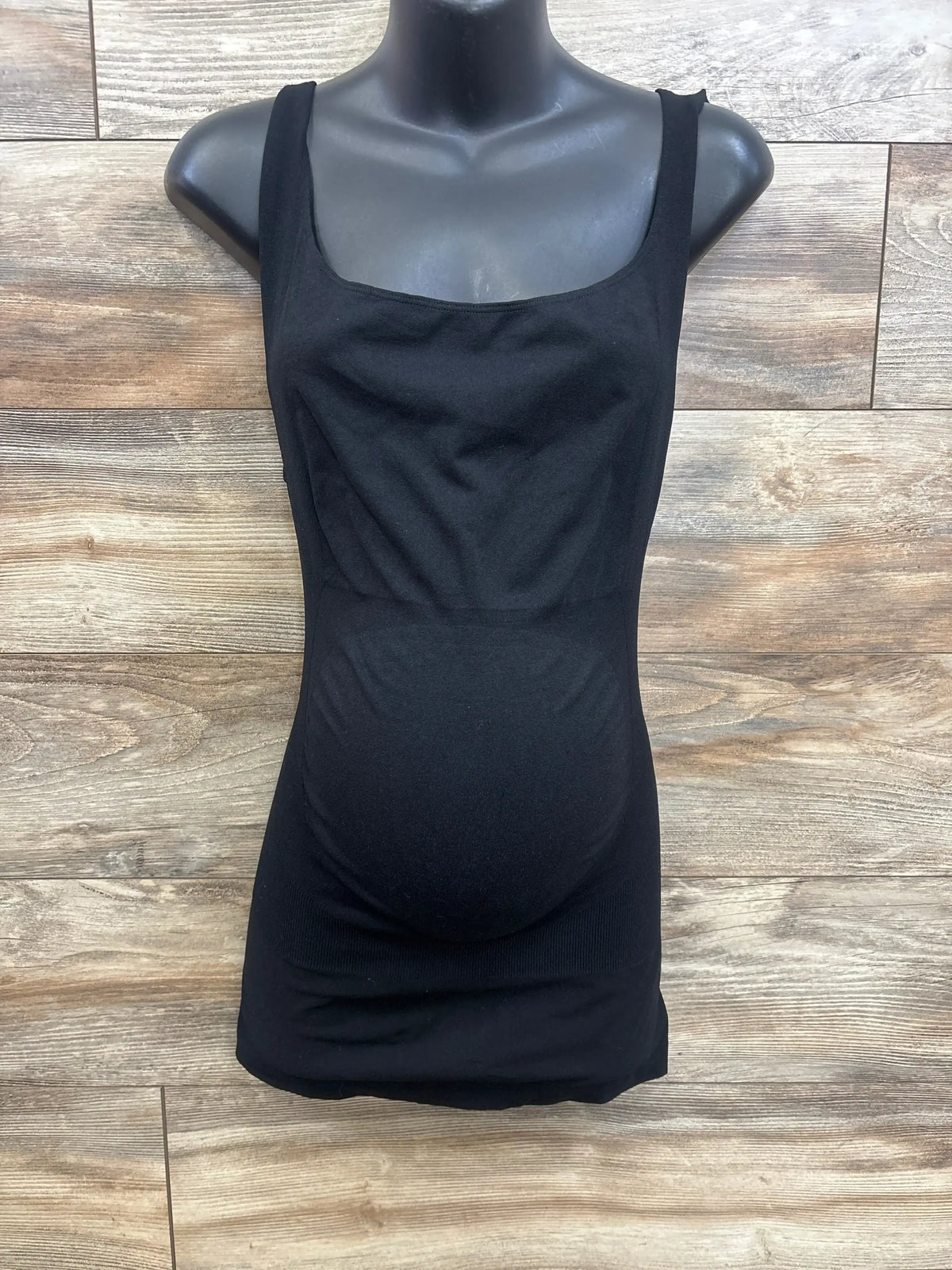 Front view of Blanqi black maternity belly support tank top showcasing scoop neck and longer length on a mannequin