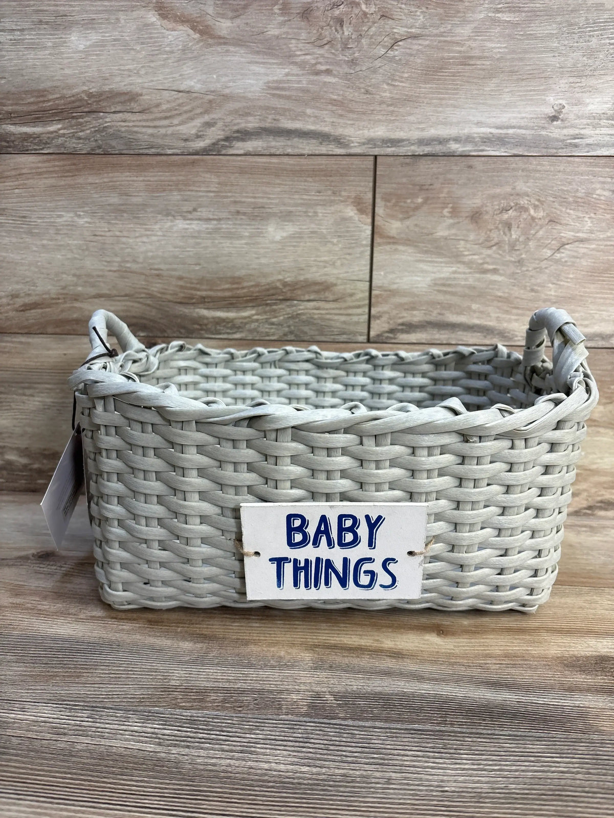 Gray woven basket with 'BABY THINGS' sign, perfect for nursery organization and baby gear storage
