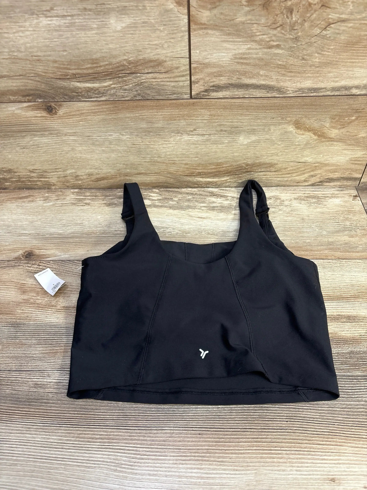 Front flat-lay of Old Navy nursing sports bra showing wide straps with nursing clip and longline band on wood background