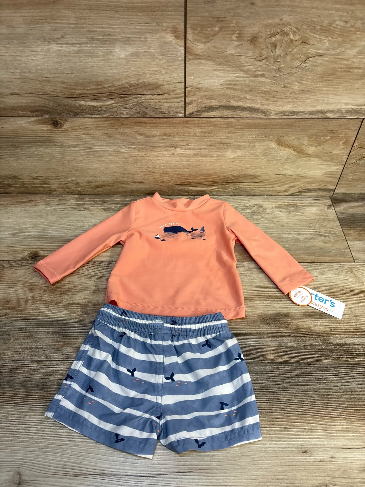 Toddler swimsuit set with coral long-sleeve rash guard and whale print swim trunks