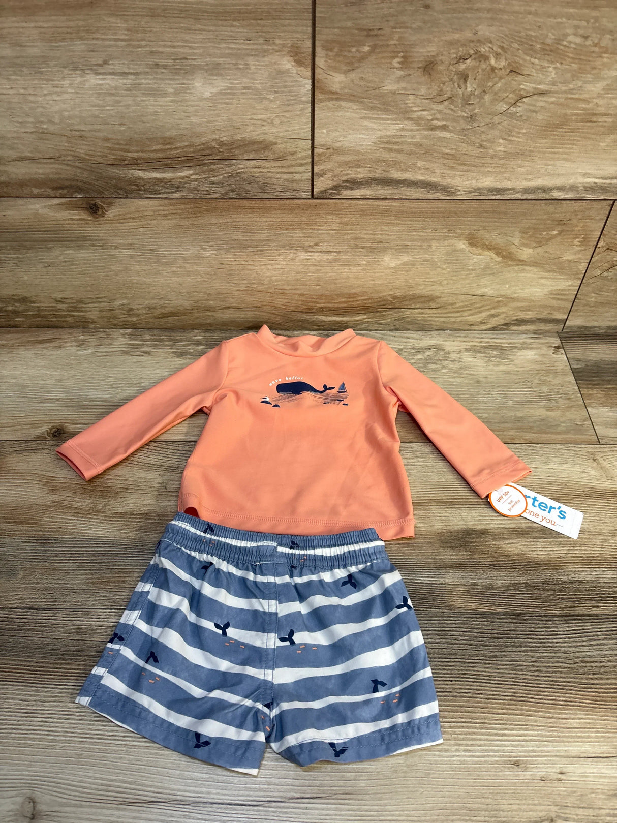 Toddler swimsuit set with coral long-sleeve rash guard and whale print swim trunks