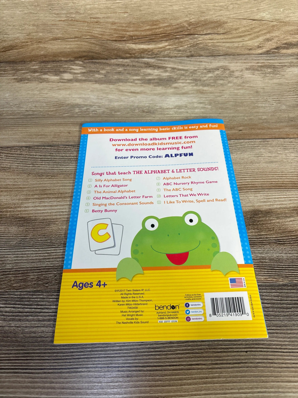 Back cover of Bendon Alphabet Fun Activity Book showing alphabet songs, frog illustration, and ages 4+