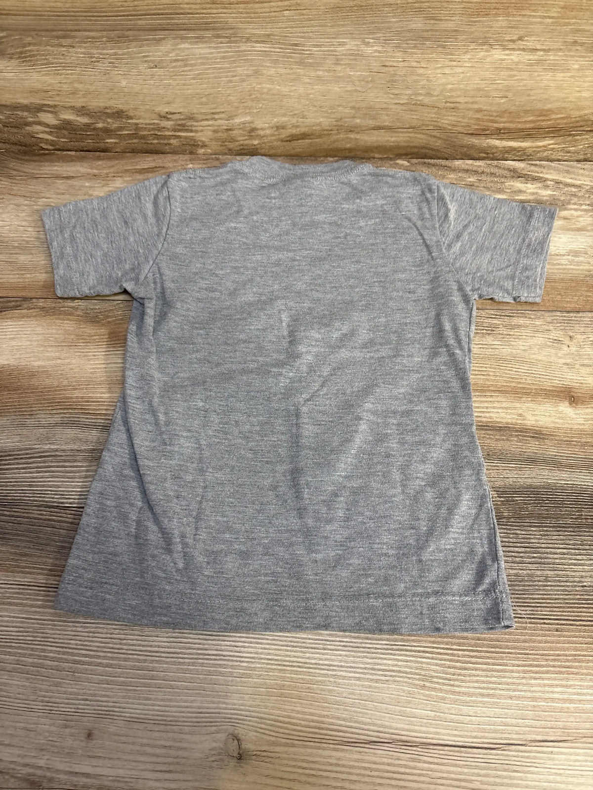 Back view of grey toddler (4T) short-sleeve shirt showcasing heathered fabric and straight hem on wooden floor background