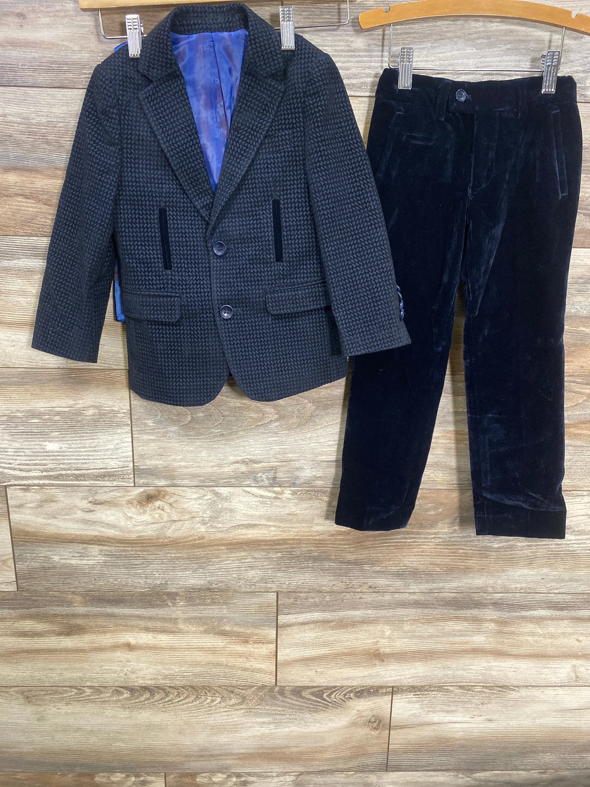Front view of Isaac Mizrahi New York navy velvet suit set showing patterned blazer and velvet pants on a wooden background