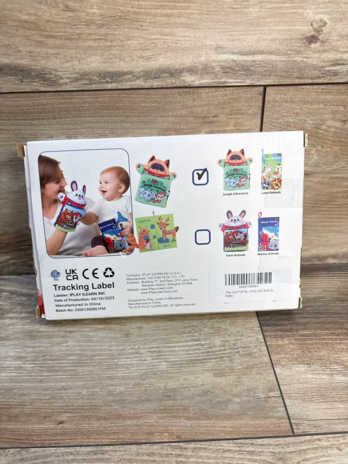 Front view of iPlay iLearn 2-pack baby zoology soft books showing Jungle Adventure and Land Animals covers with demo photo of an adult and baby