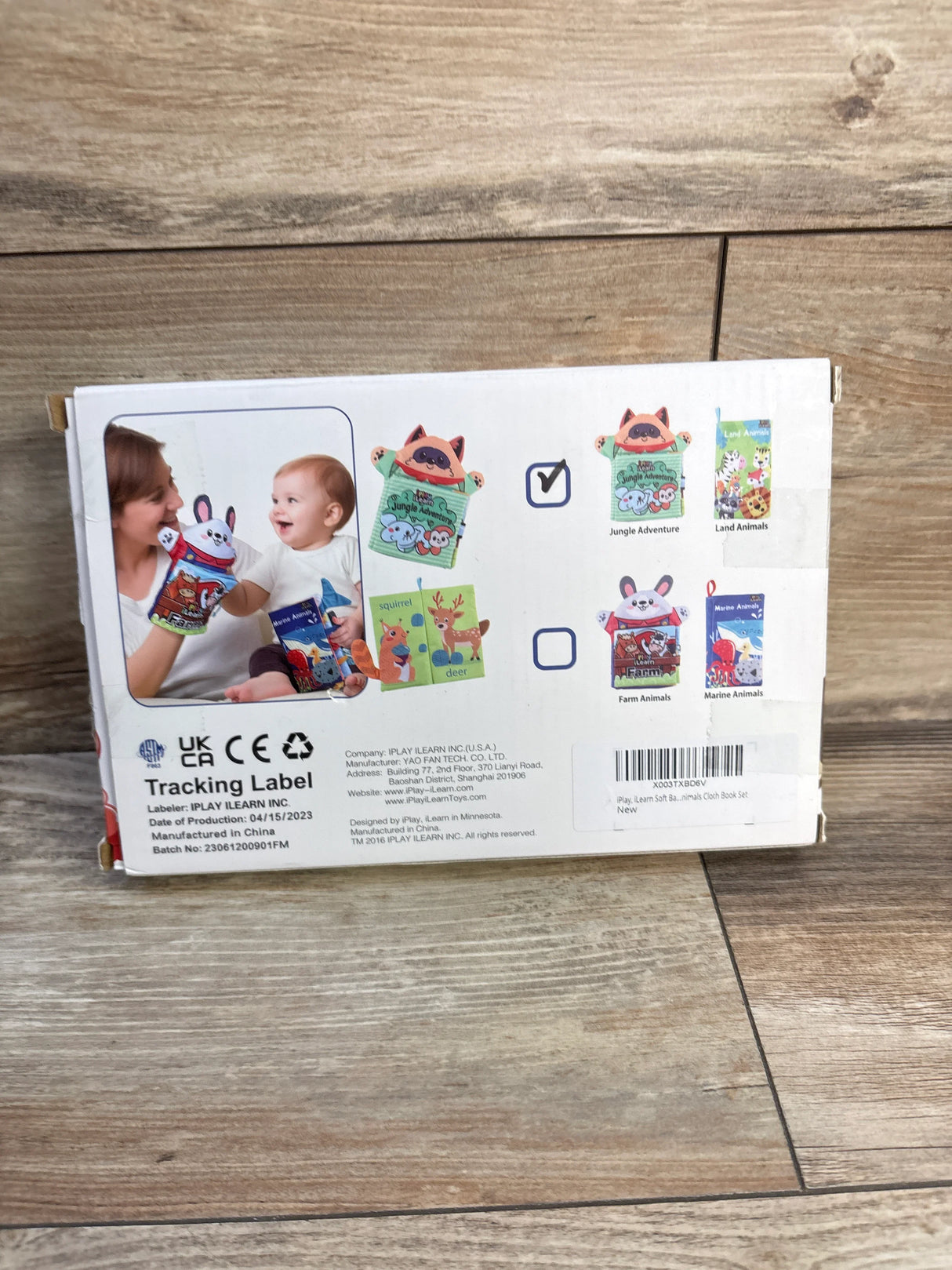 Front view of iPlay iLearn 2-pack baby zoology soft books showing Jungle Adventure and Land Animals covers with demo photo of an adult and baby