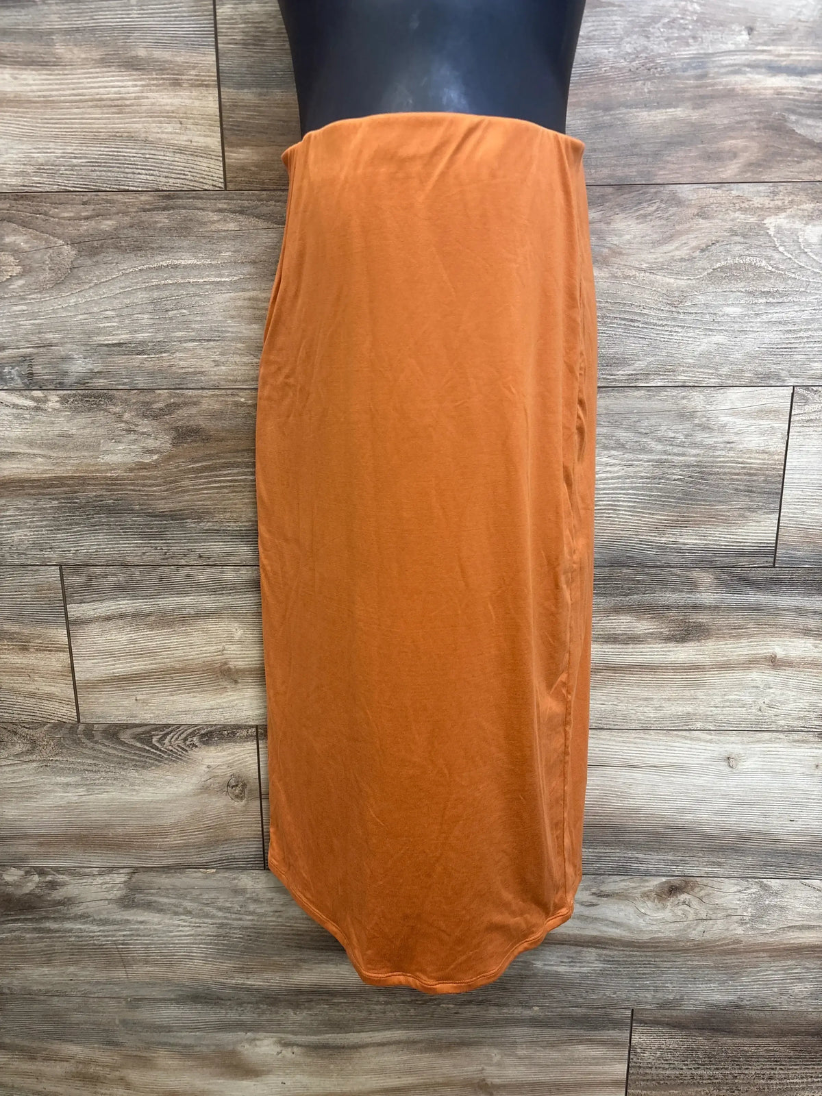 Front view of Poshdivah maternity skirt showcasing fold-over waistband and straight maxi fit on a black mannequin with wood background