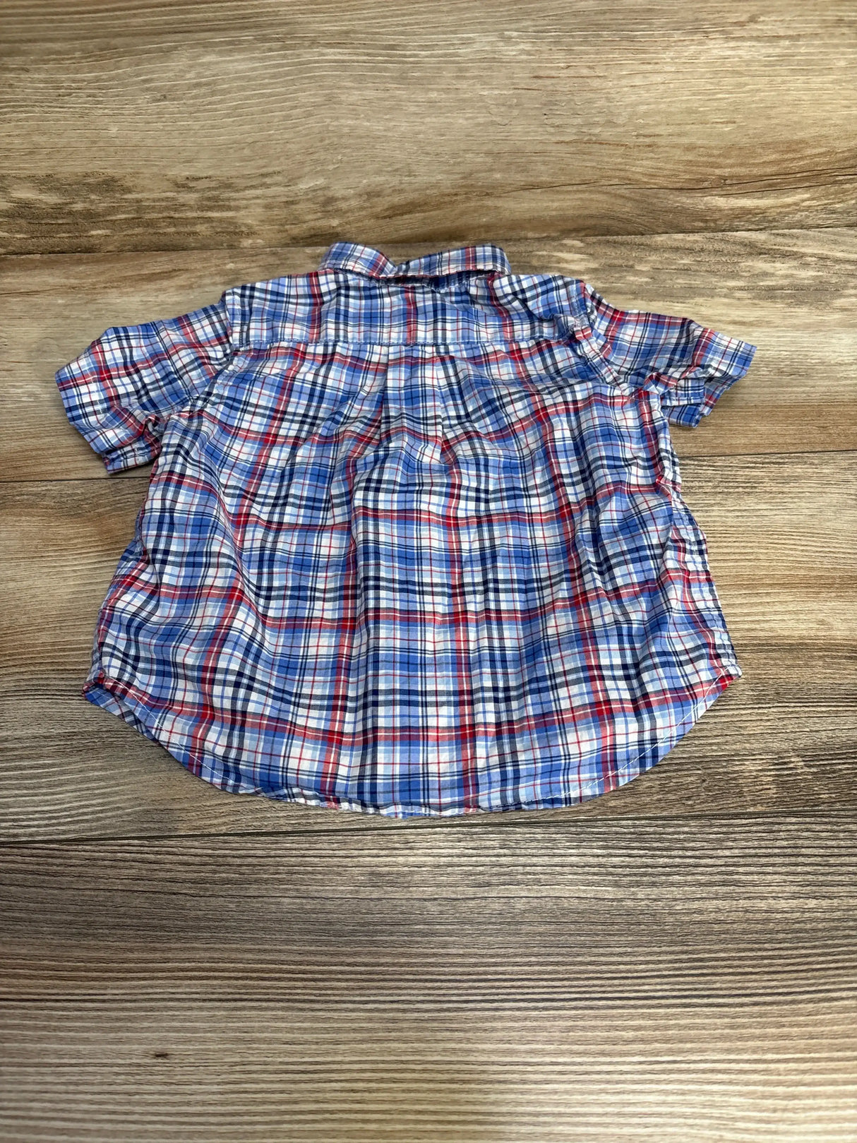 Back view of Ralph Lauren baby plaid button-down shirt size 9M showing blue-and-red plaid pattern and short sleeves on wood background