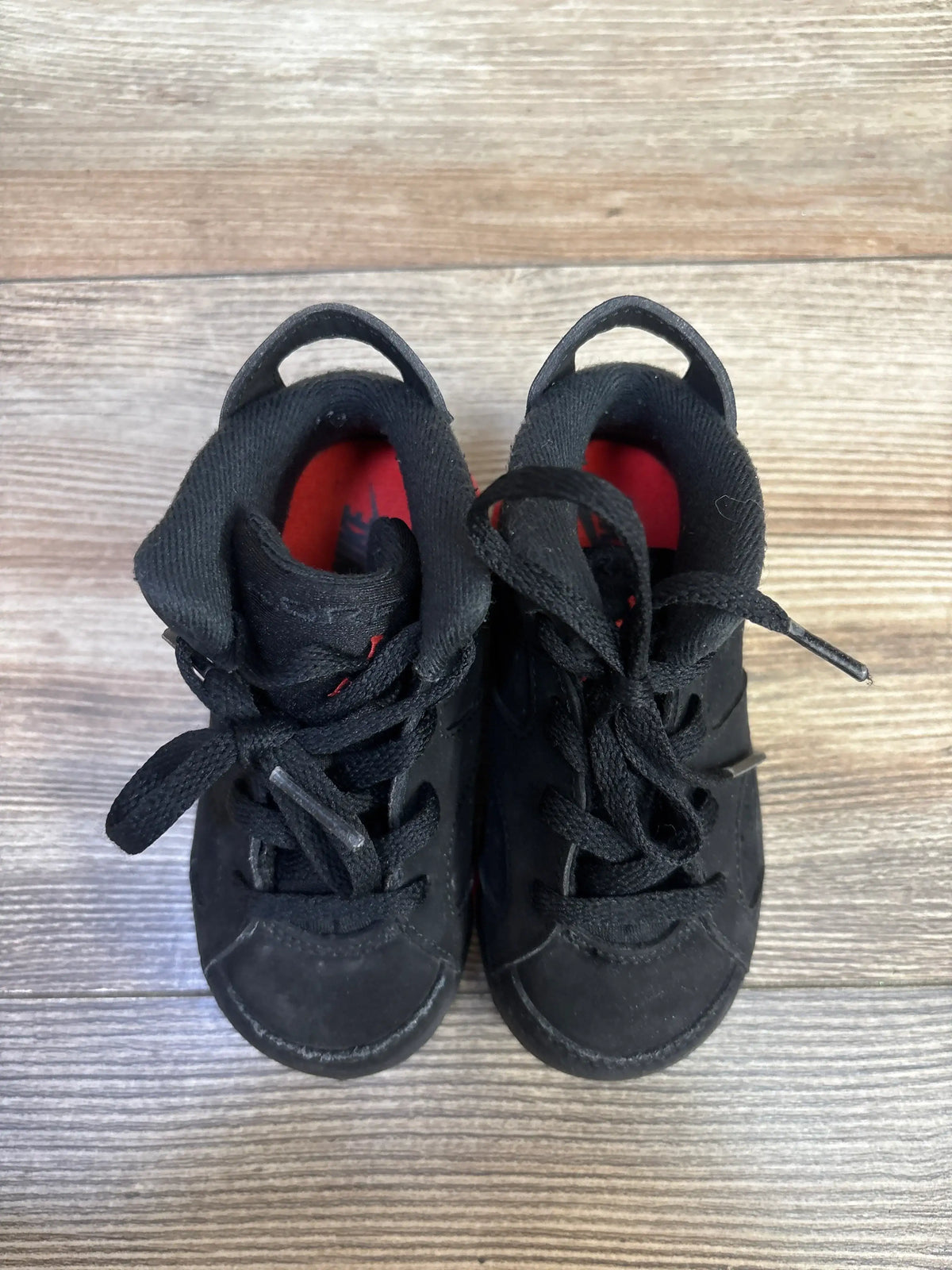 Top view of Air Jordan 6 Retro TD Infrared sneakers with black suede uppers, red lining, and padded tongues