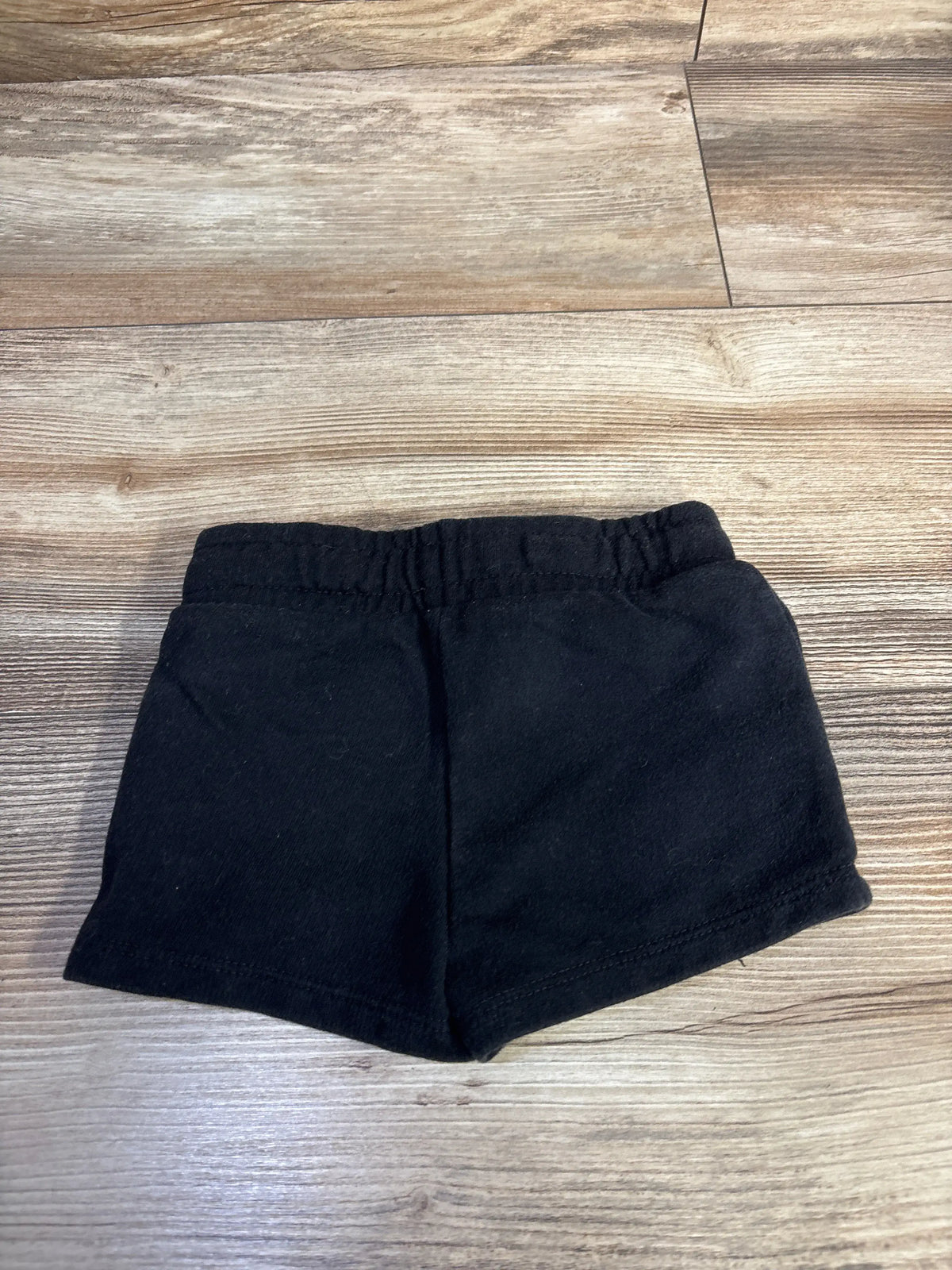 Cat & Jack black knit baby shorts size 12m on a wooden surface