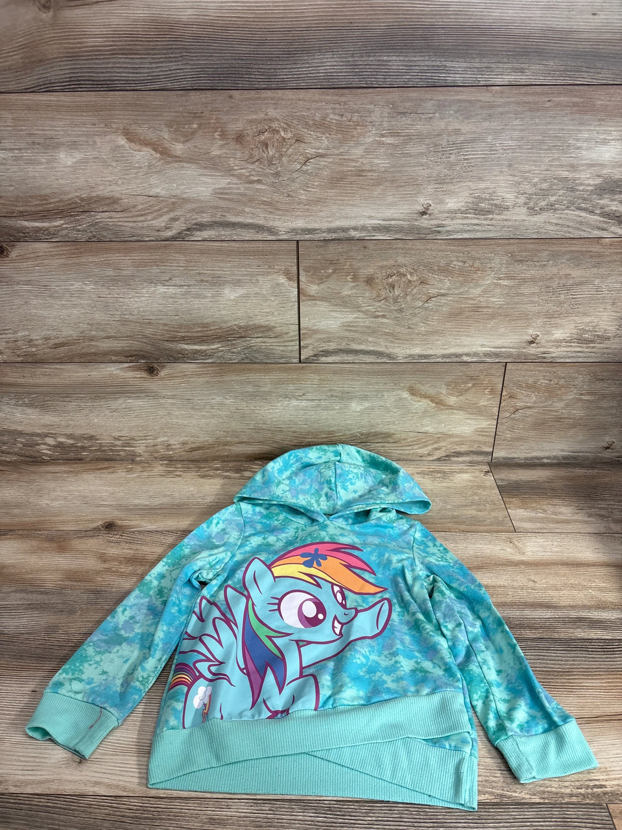 Front view of teal toddler My Little Pony pullover hoodie showing large Rainbow Dash graphic, hood and crossover hem