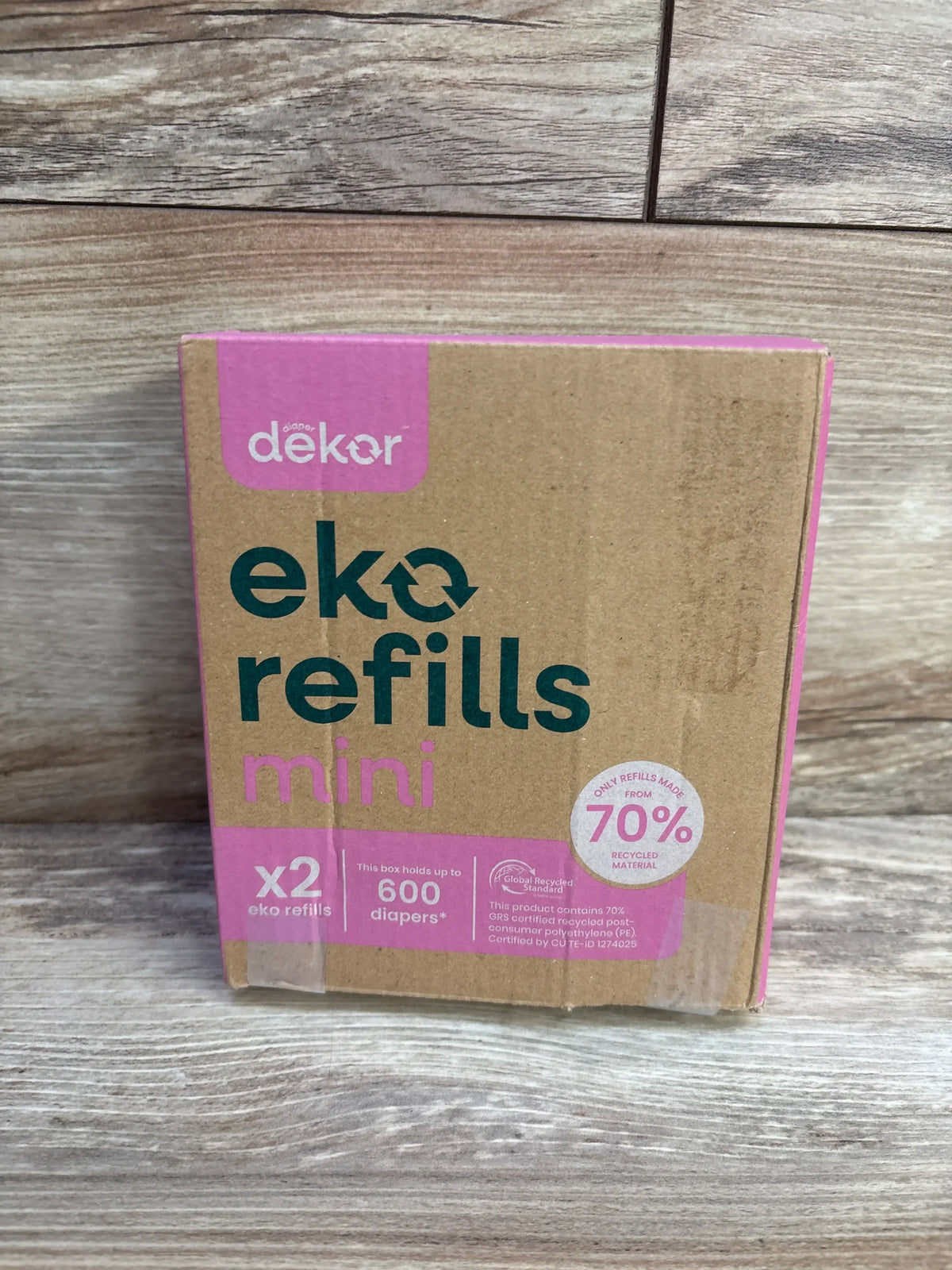 Front of Diaper Dekor Eko refills mini 2-pack box showing eko refills mini text, x2 label and 600 diapers claim on wood background