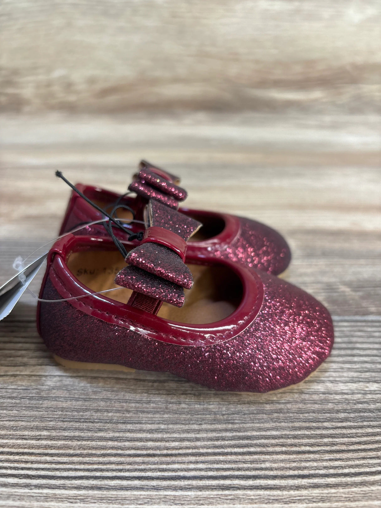 Sparkly burgundy baby girl shoes with bow, perfect for infants and toddlers