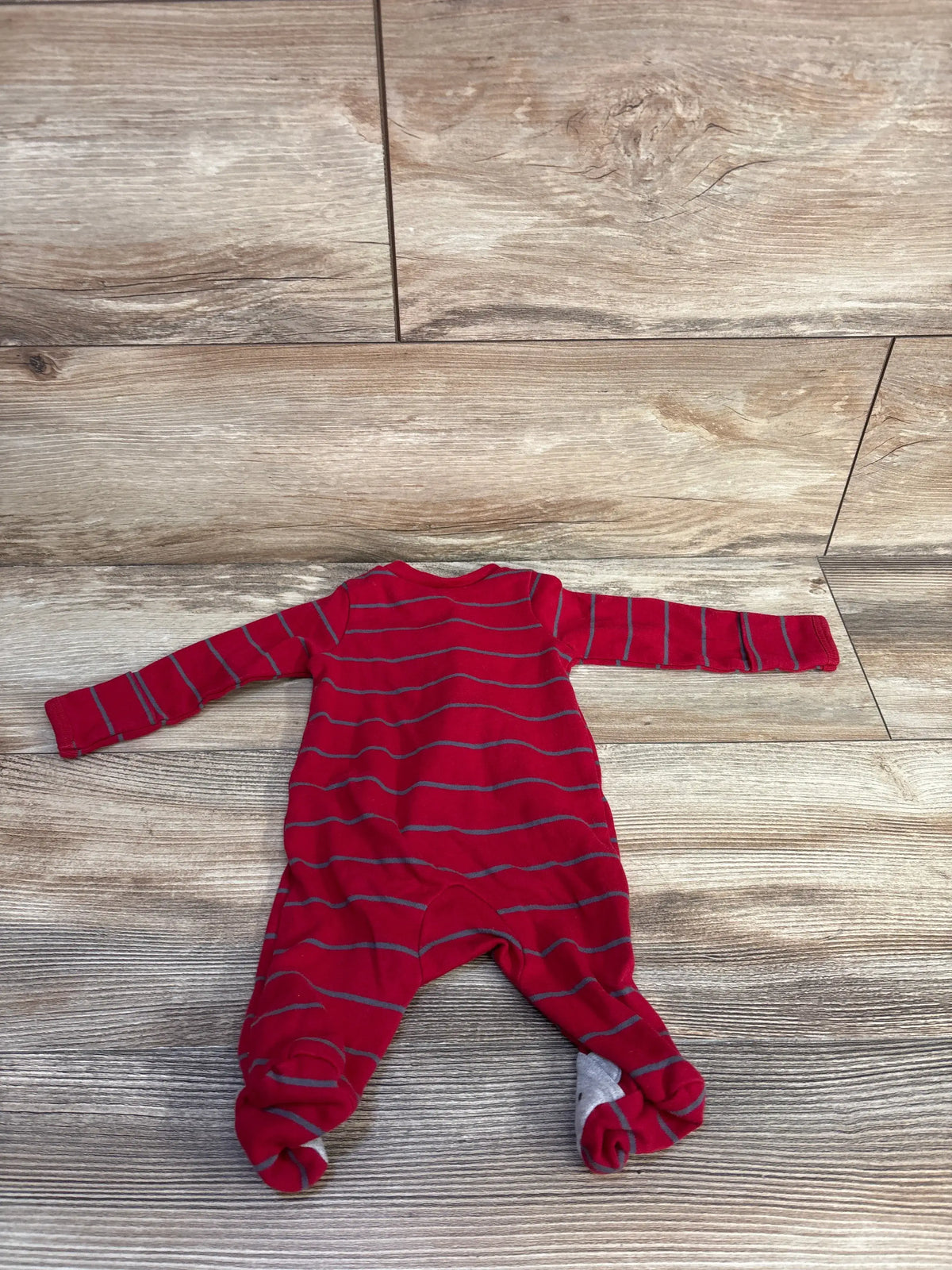Front view of the Just One You Love You More sleeper with gray stripes and footed legs on a wood-look floor