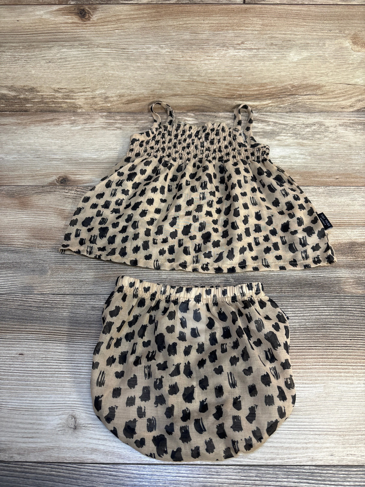 Toddler leopard print sleeveless top and bloomer shorts set on wood background