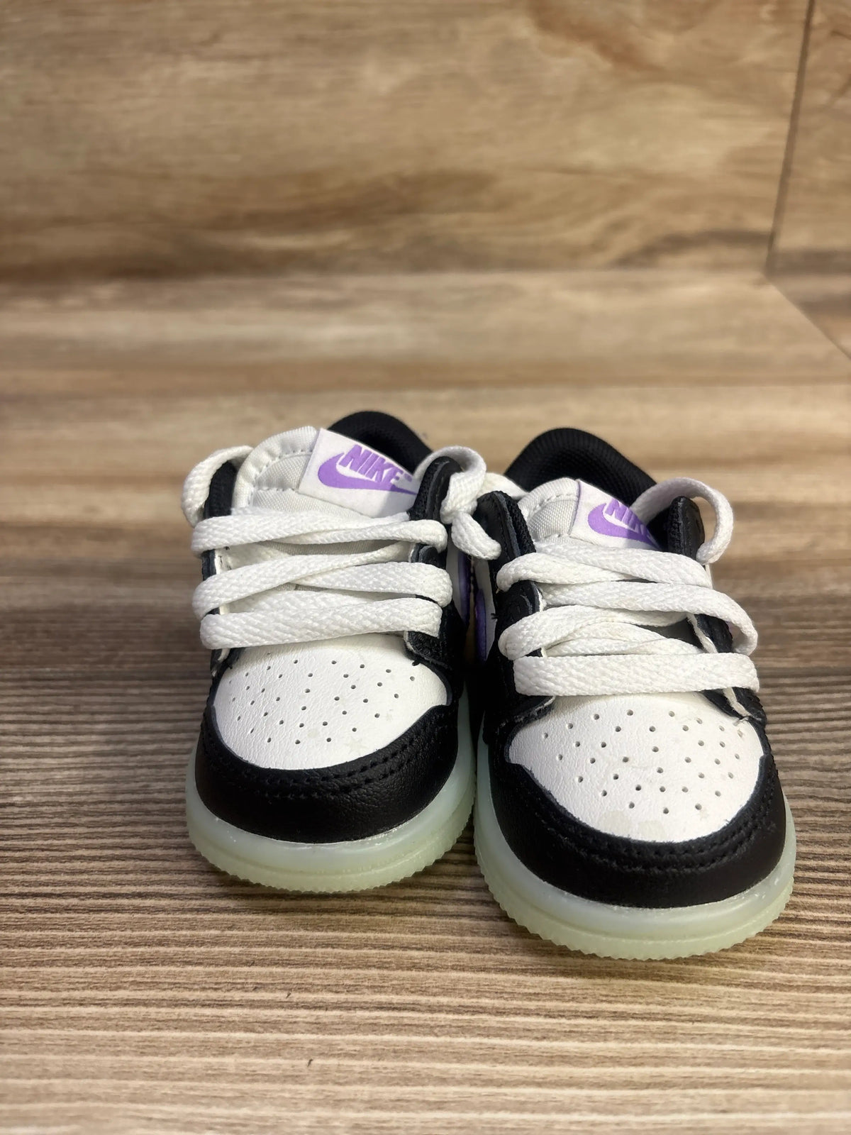 Front view of Air Jordan 1 Retro Low OG TD Black Raspberry sneakers showcasing purple Nike logos and translucent soles