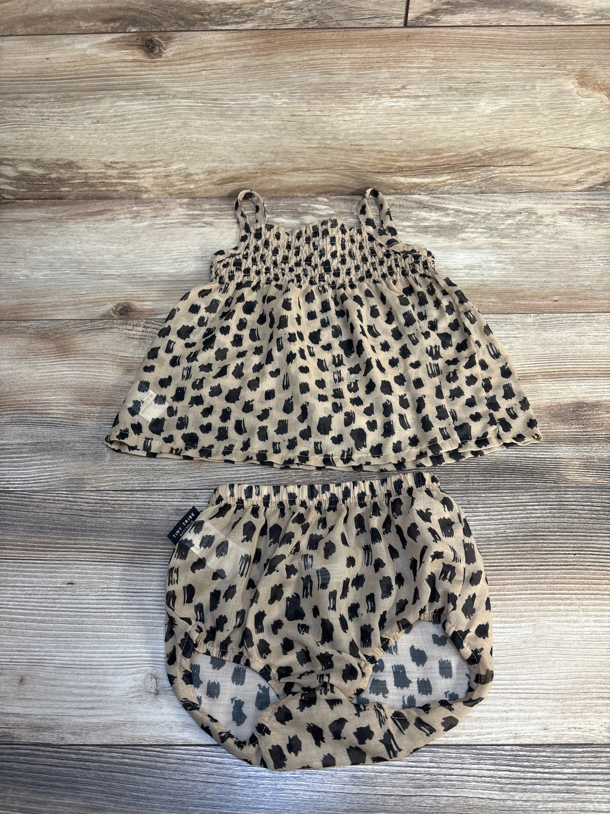 Leopard print infant top and bloomer shorts set on wood background