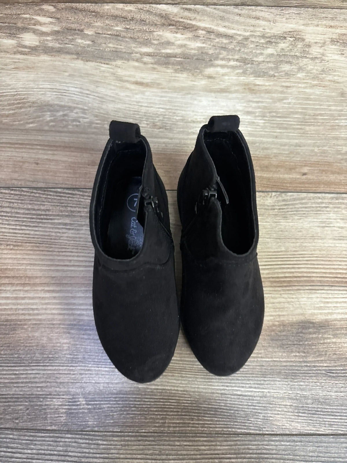 Top view of Cat & Jack Penelope toddler black suede ankle boots size 7C with side zippers on wood floor