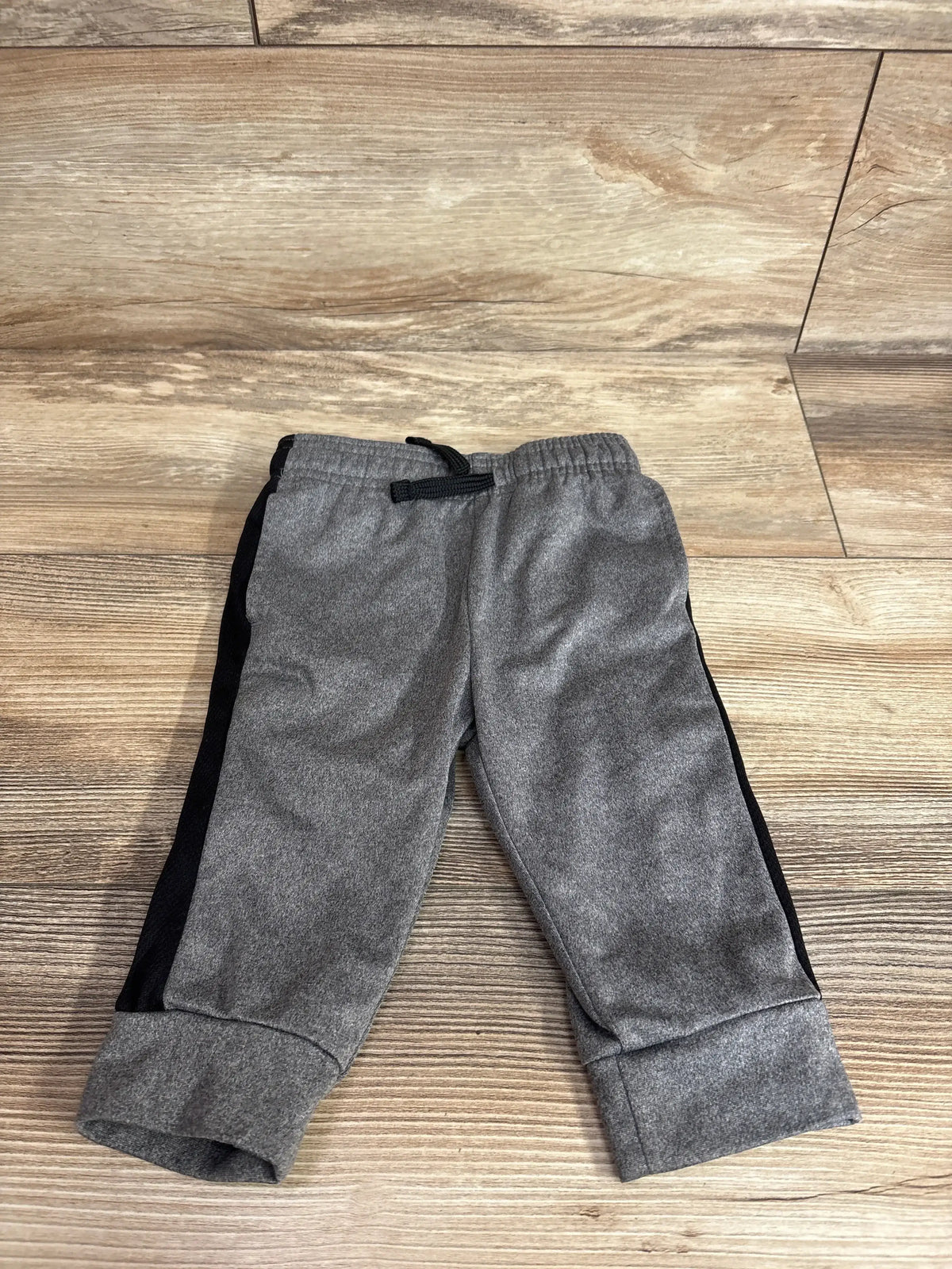 Front view of Jumping Beans grey toddler joggers (12 months) showing elastic waistband and cuffed ankles on white background