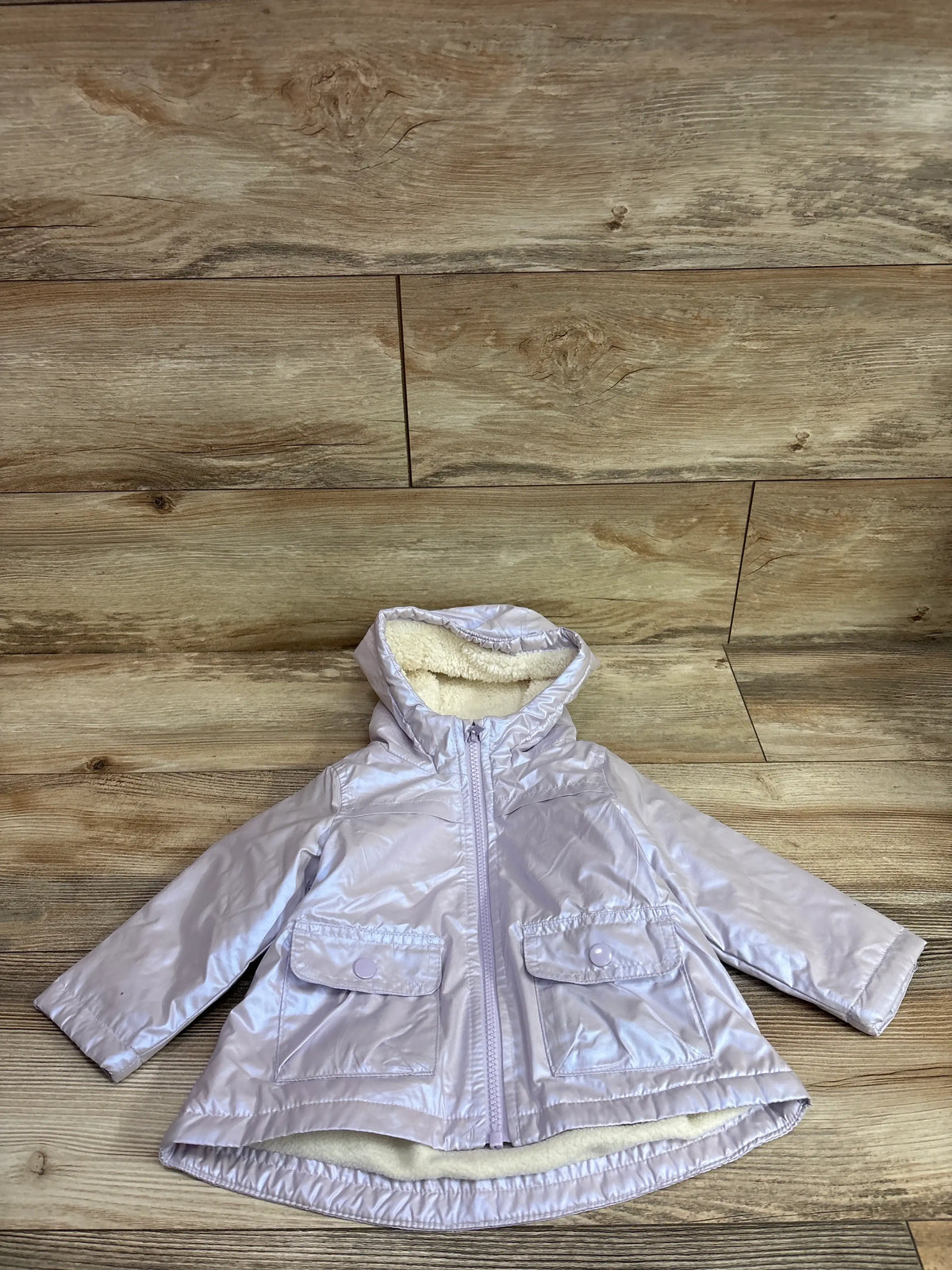 Carter's metallic purple midweight lined jacket for toddlers on a wood background