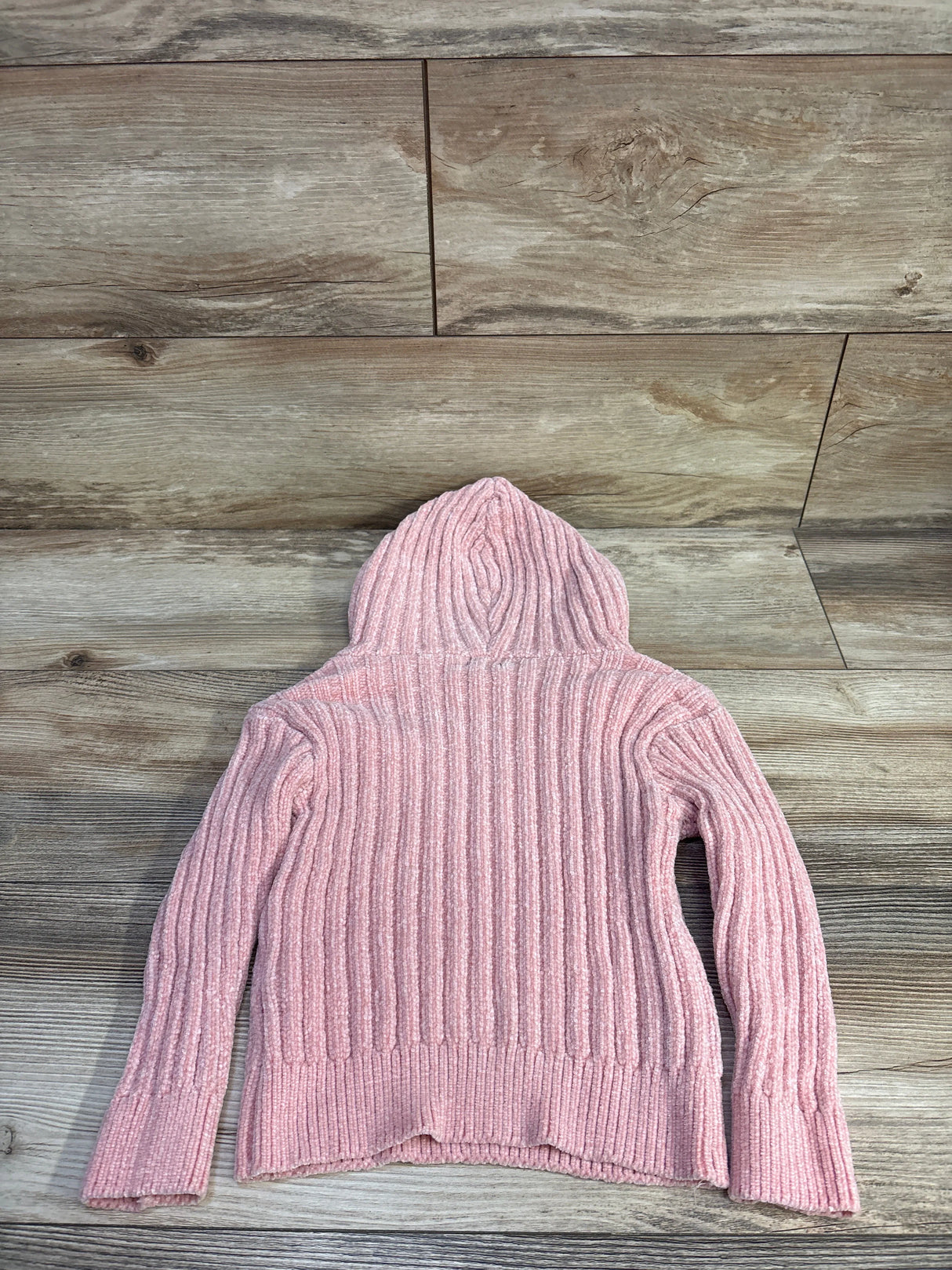 Back view of pink DKNY knit velour hooded toddler sweater size 3T showing ribbed texture and hood on light wood background