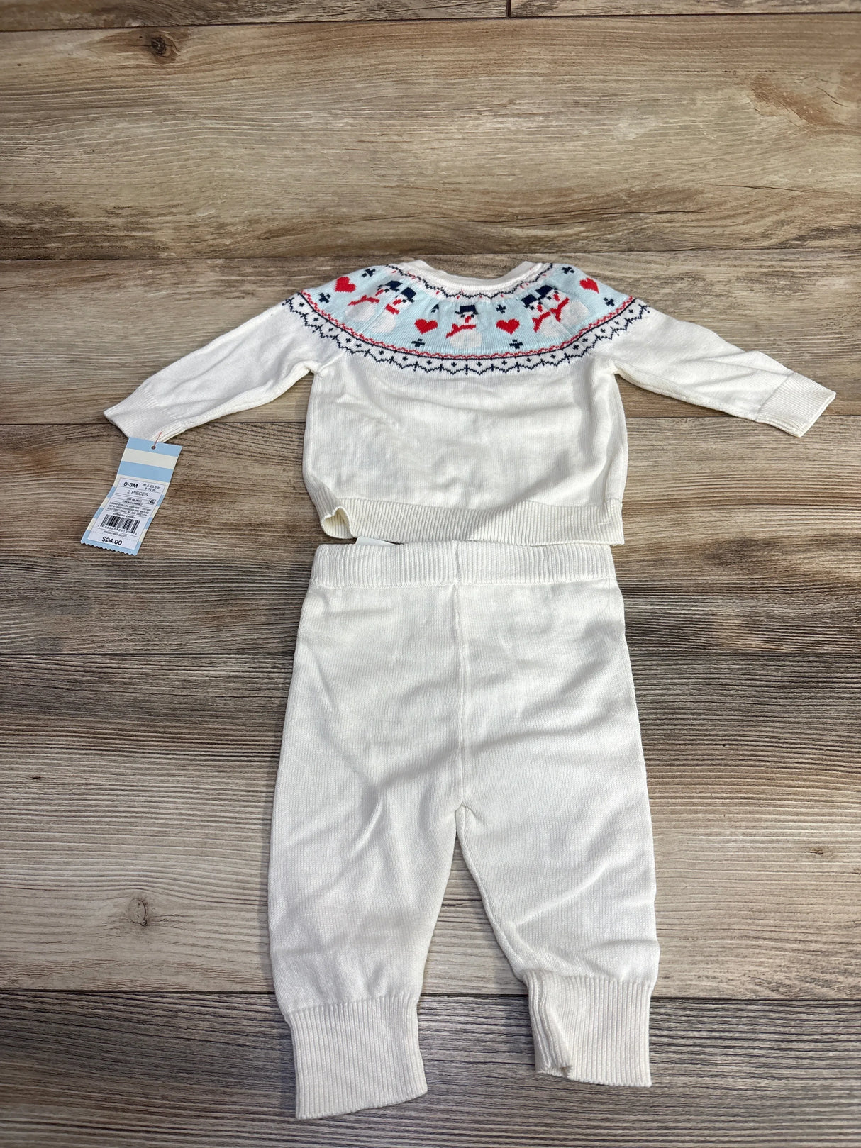 White baby knit sweater and pants set with red hearts and navy blue patterns