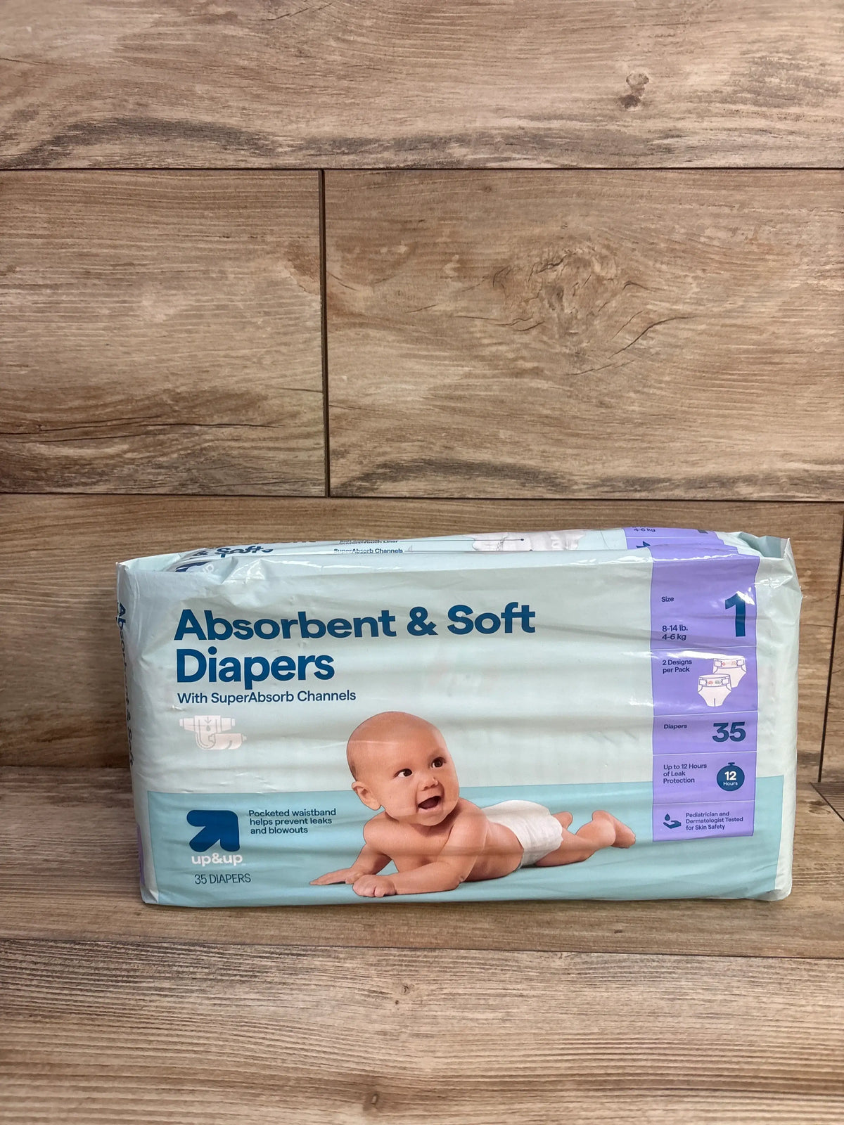 Front view of NEW up&up Absorbent and Soft Diapers Size 1 package showcasing absorbent channels and baby photo