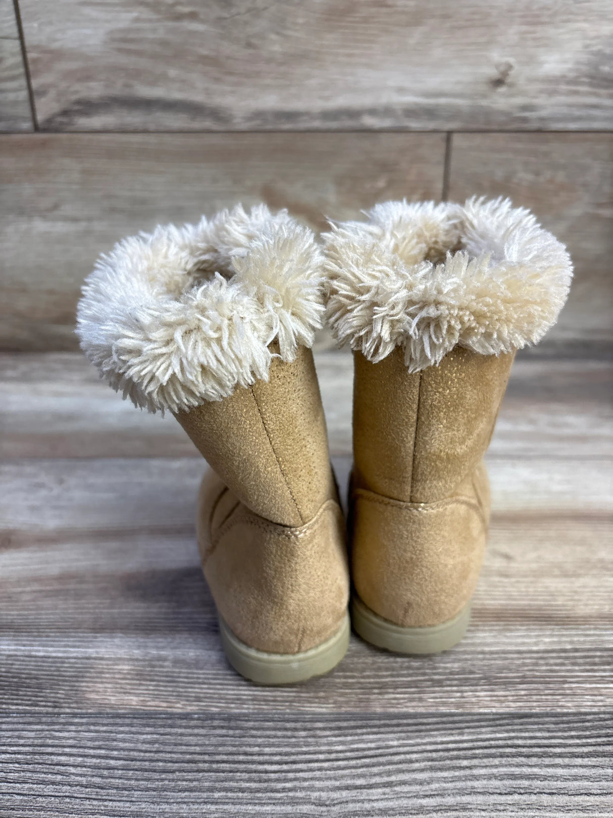 Rear view of Cat and Jack Leah toddler winter boots showing plush faux fur cuff and suede upper on wooden floor