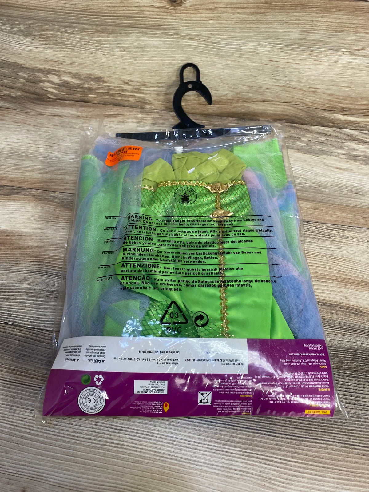 Back view of Rubies Twinklers Twinkle Fairy Costume size 8 to 10 showing green and purple costume pieces through plastic packaging
