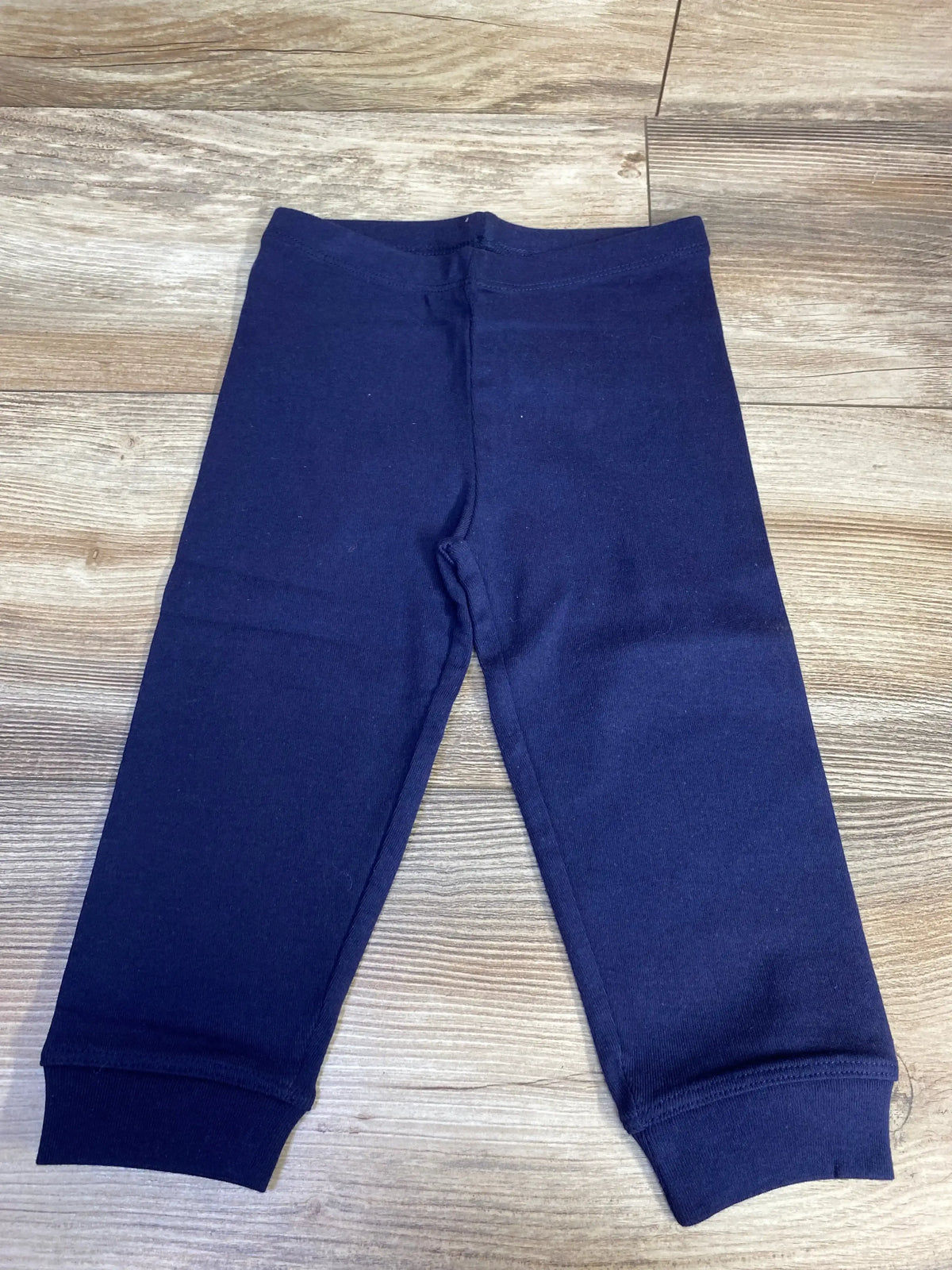 Navy blue toddler pants on wooden floor, kids clothing apparel