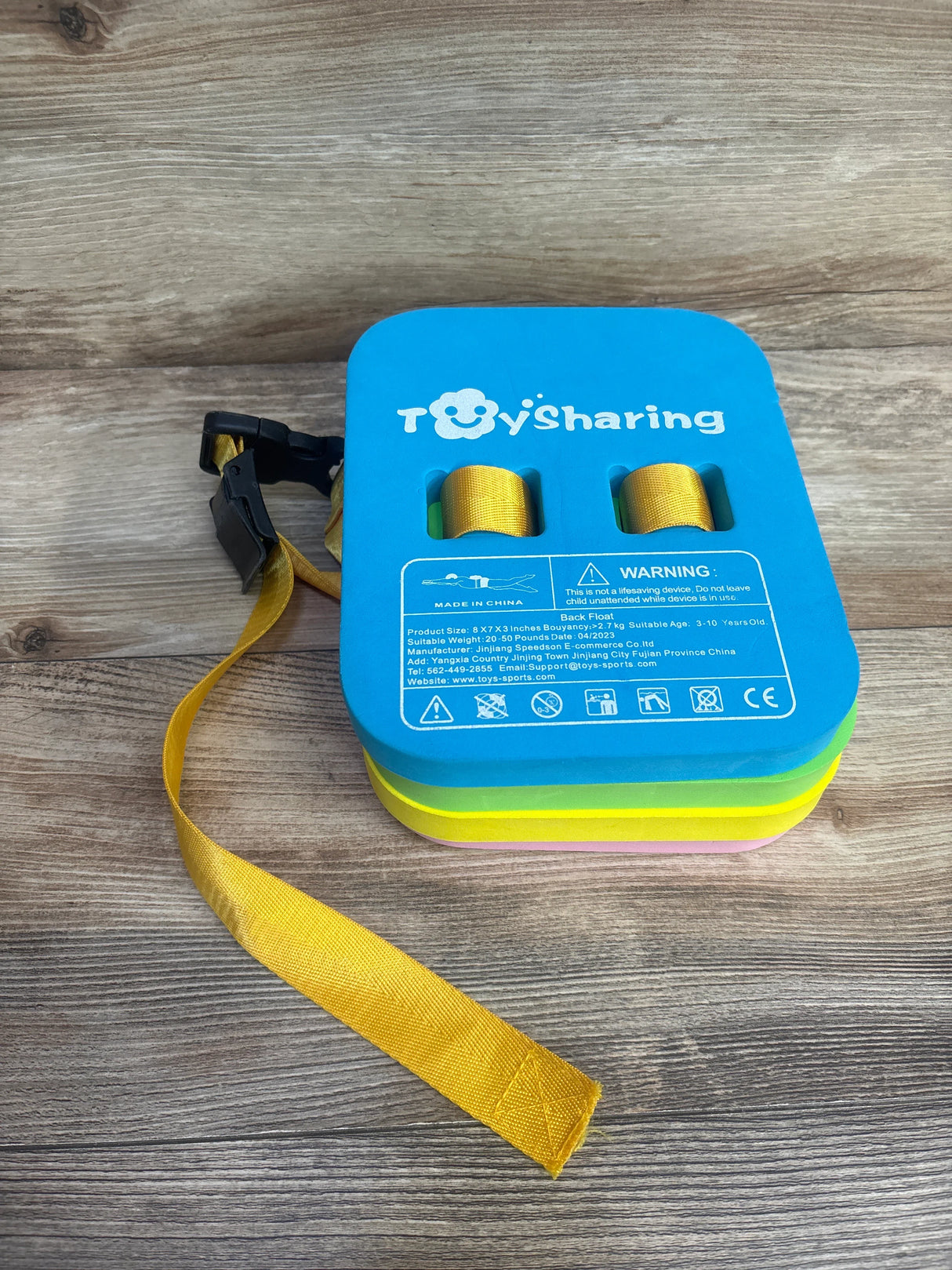 ToySharing kids swim belt with yellow strap on wooden surface, blue foam float
