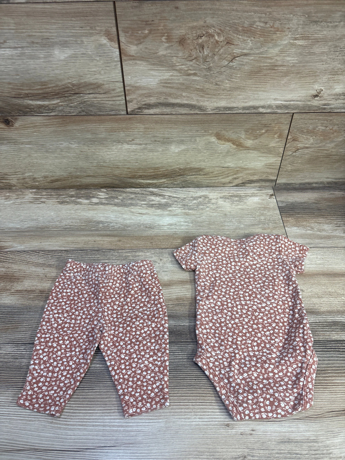Front view of brown bodysuit and footed pants set, size 3 months, with white floral print