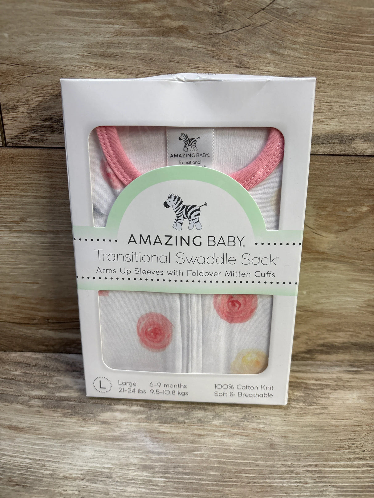Front of Amazing Baby Transitional Swaddle Sack showcasing arms up sleeves and foldover mitten cuffs on wooden surface