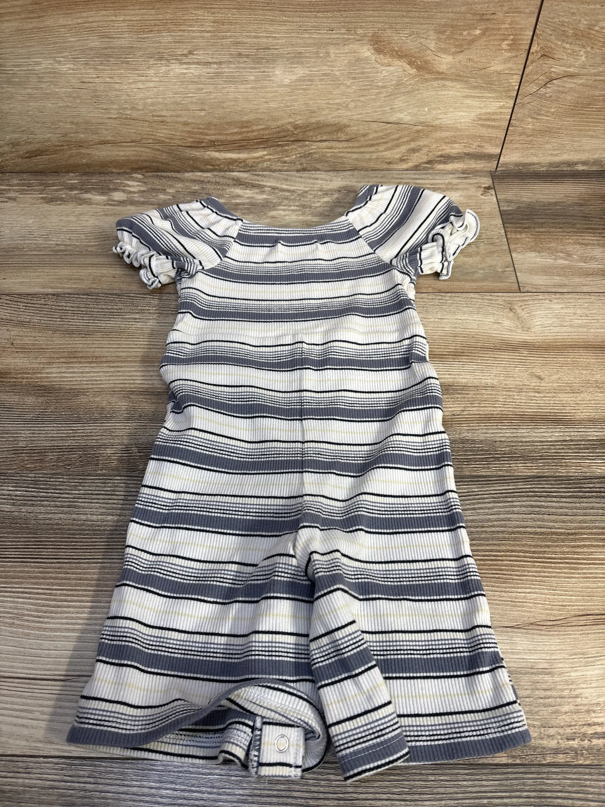 White and blue striped baby jumpsuit by Me n Mommy To Be on a wooden surface