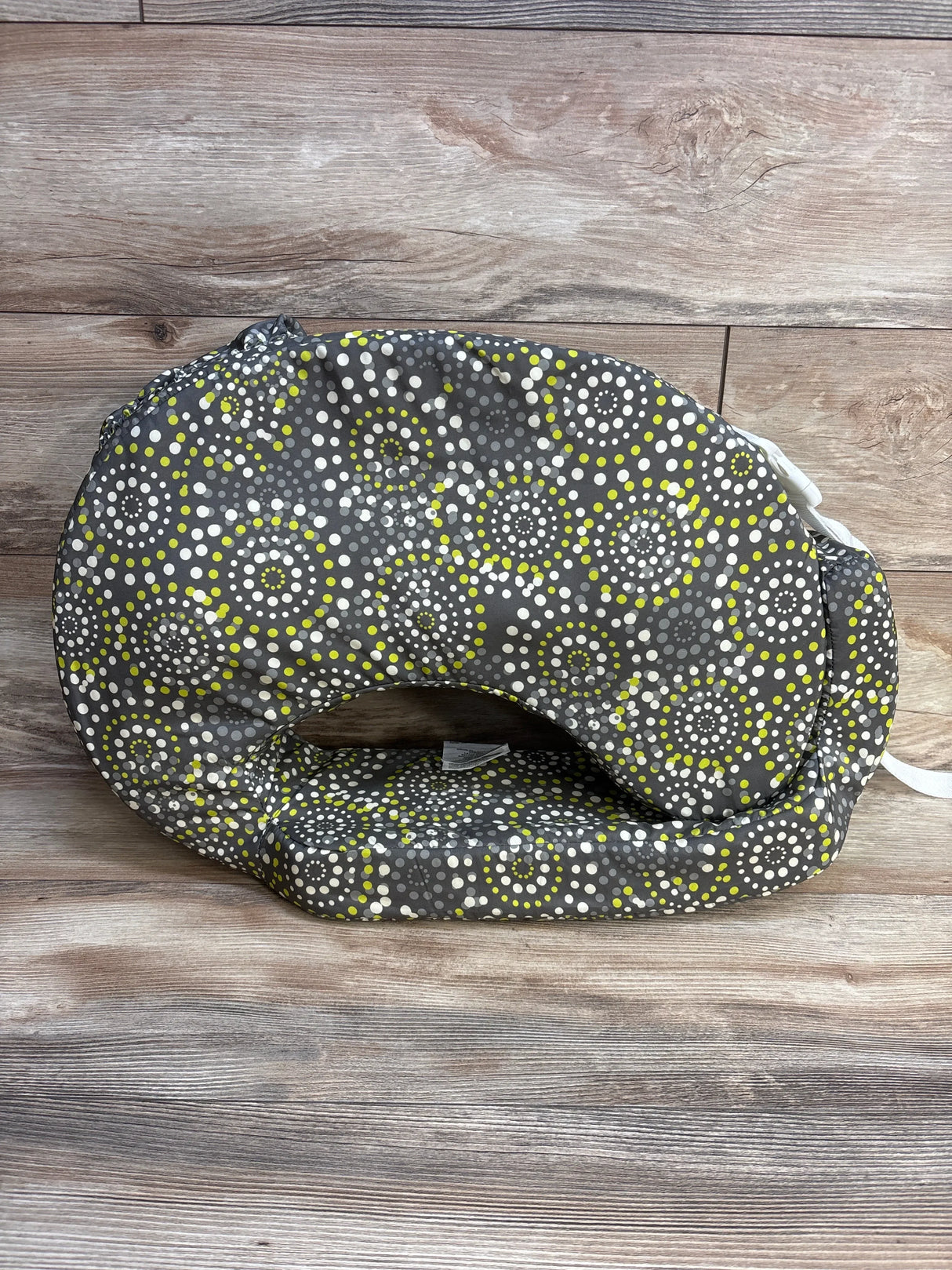Front view of My Brest Friend nursing pillow, Fireworks pattern, contoured back and flat feeding surface on wood background