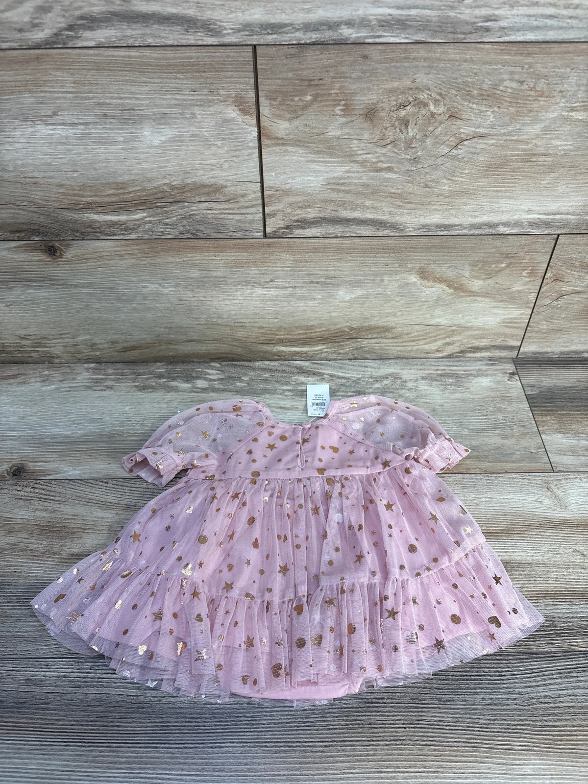 Front view of pink Baby Gap dress and bloomers set showcasing metallic tulle and tiered skirt on wood flooring