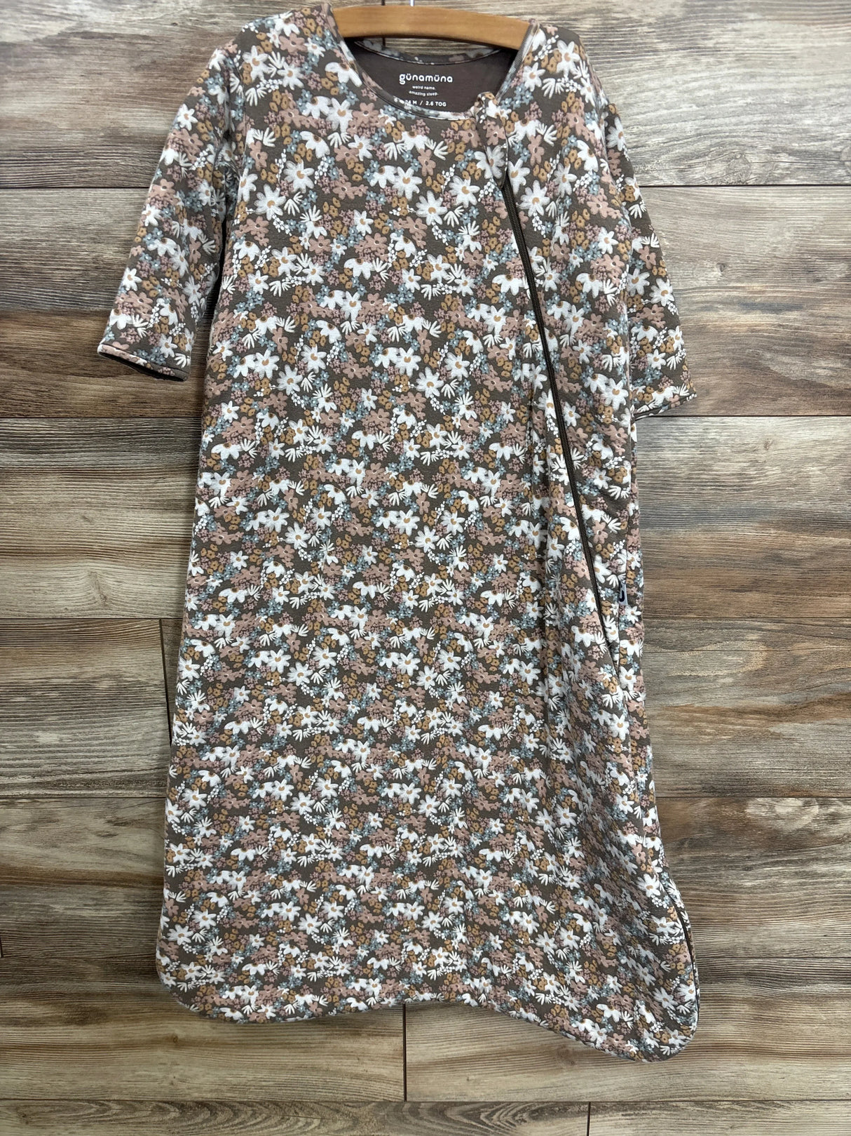 Front of brown floral long-sleeve 2.6 TOG sleep sack (18–24M) showing diagonal zipper and gathered waist on wood background