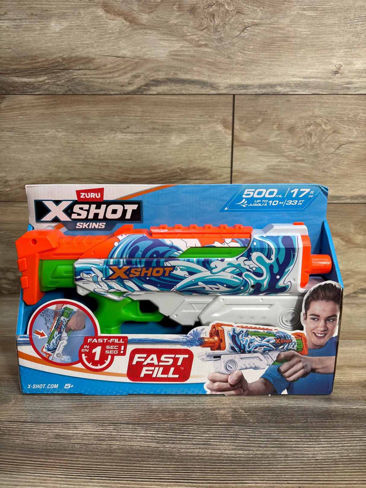 Zuru X-Shot Skins Fast-Fill water blaster toy in retail packaging on wood background