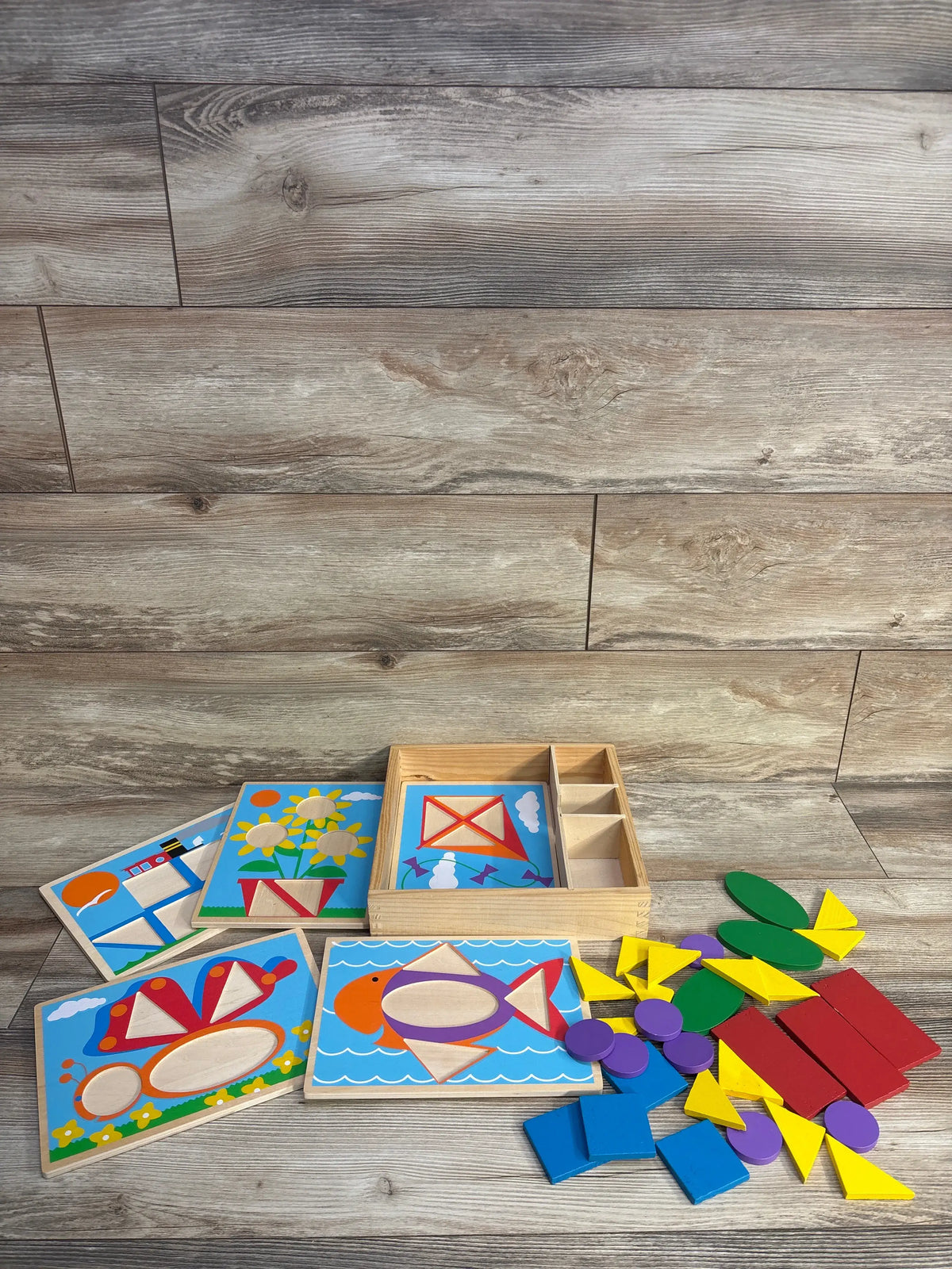 Top view of Best Learning Learning Cube showcasing colorful activity pieces on a wood-look floor