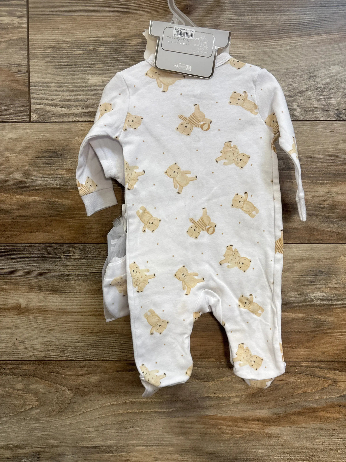 Front view of Rock a Bye Baby Boutique 5-piece gift set, showing a white teddy bear-print sleeper on wood grain