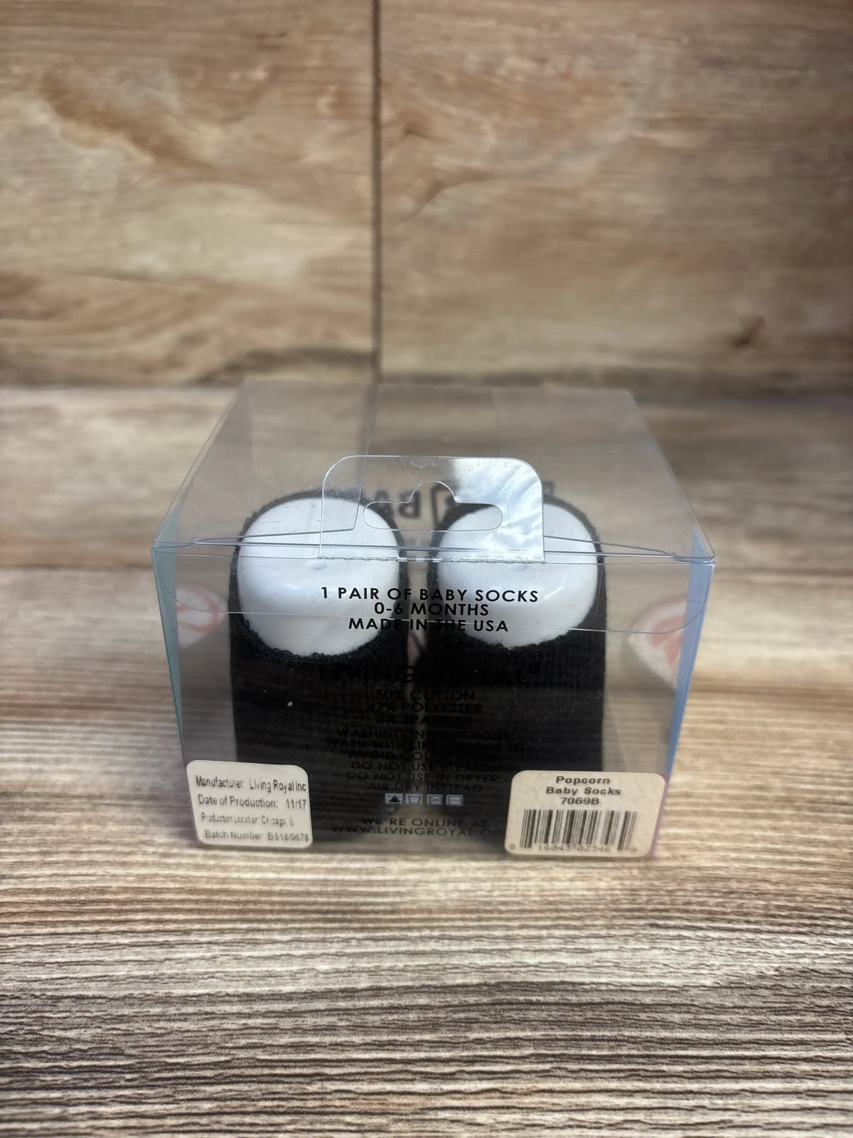 Front view of Living Royal Popcorn baby socks for ages 0 to 6 months in clear packaging